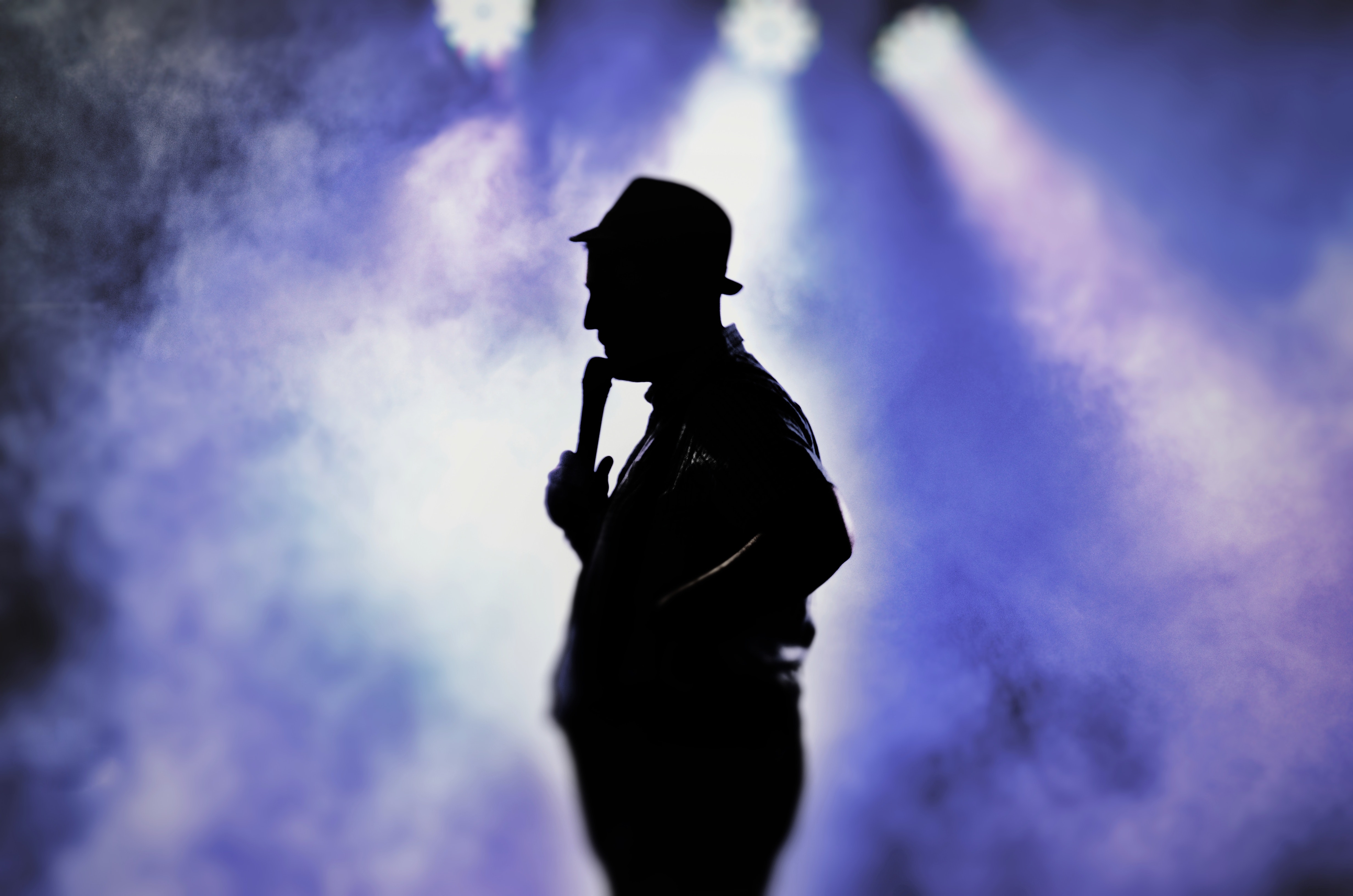 Man holding microphone silhouette photo
