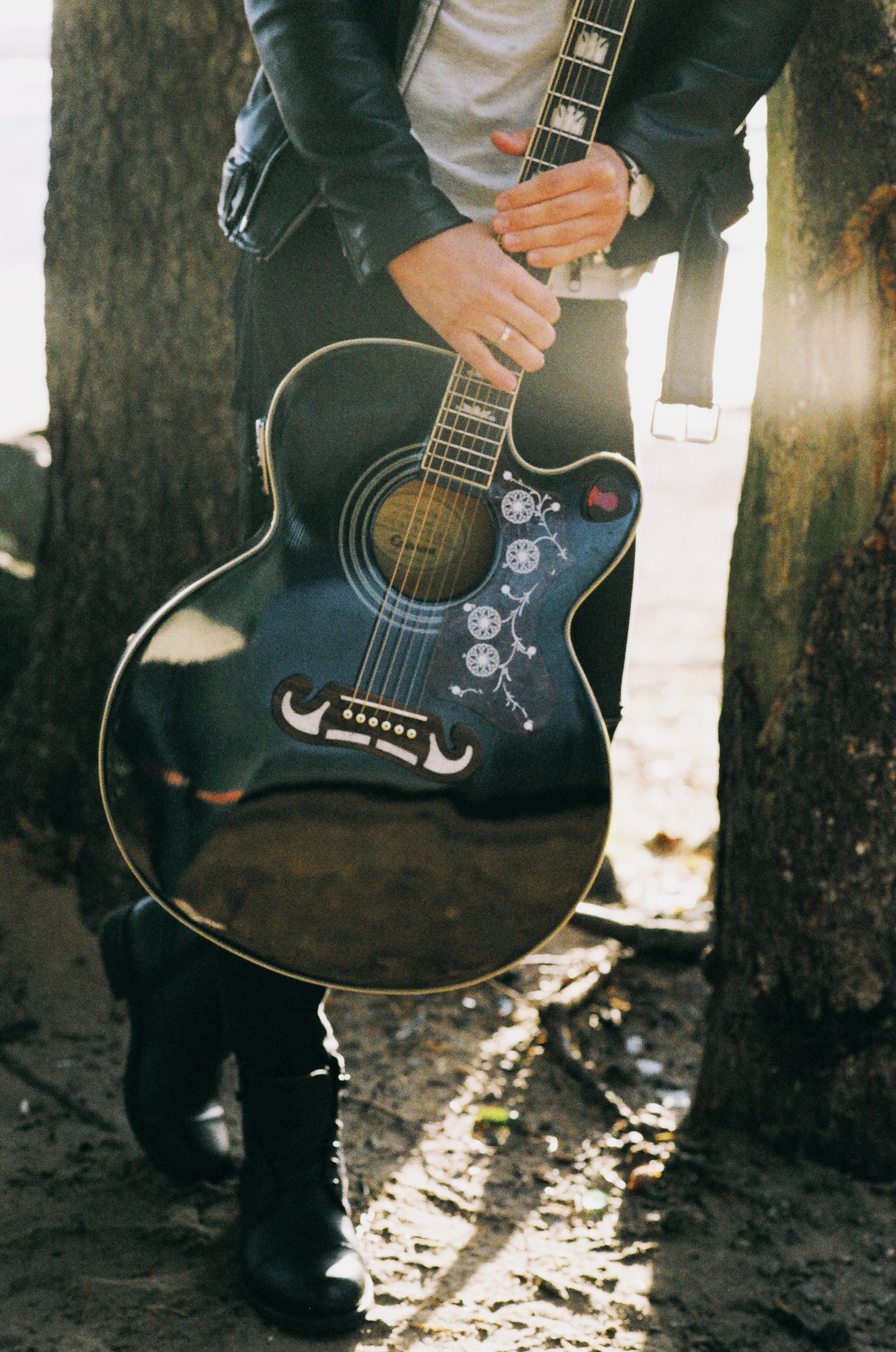 Man holding single cutaway acoustic guitar photo