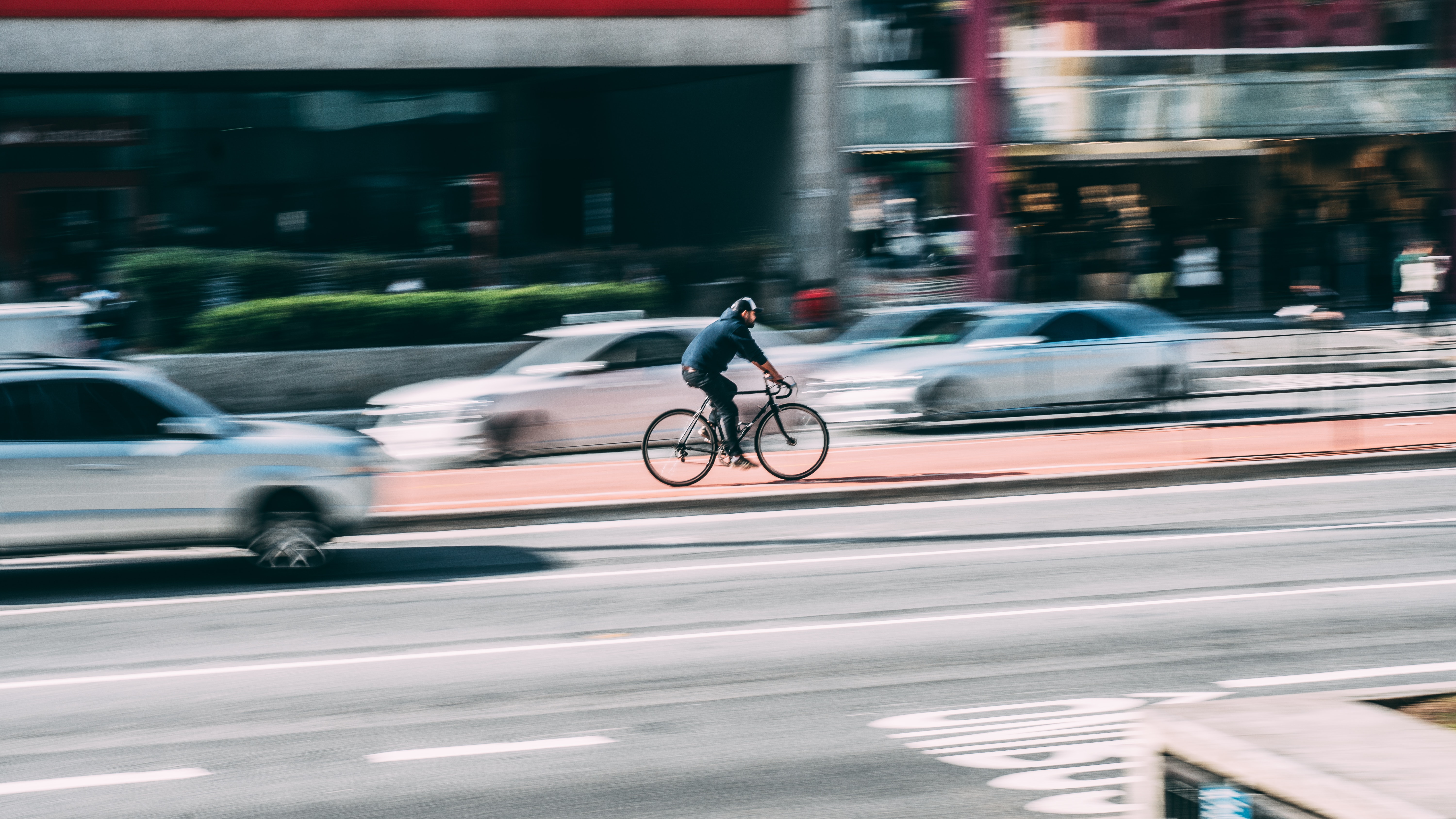 Man in black shirt using black road bicycle photo