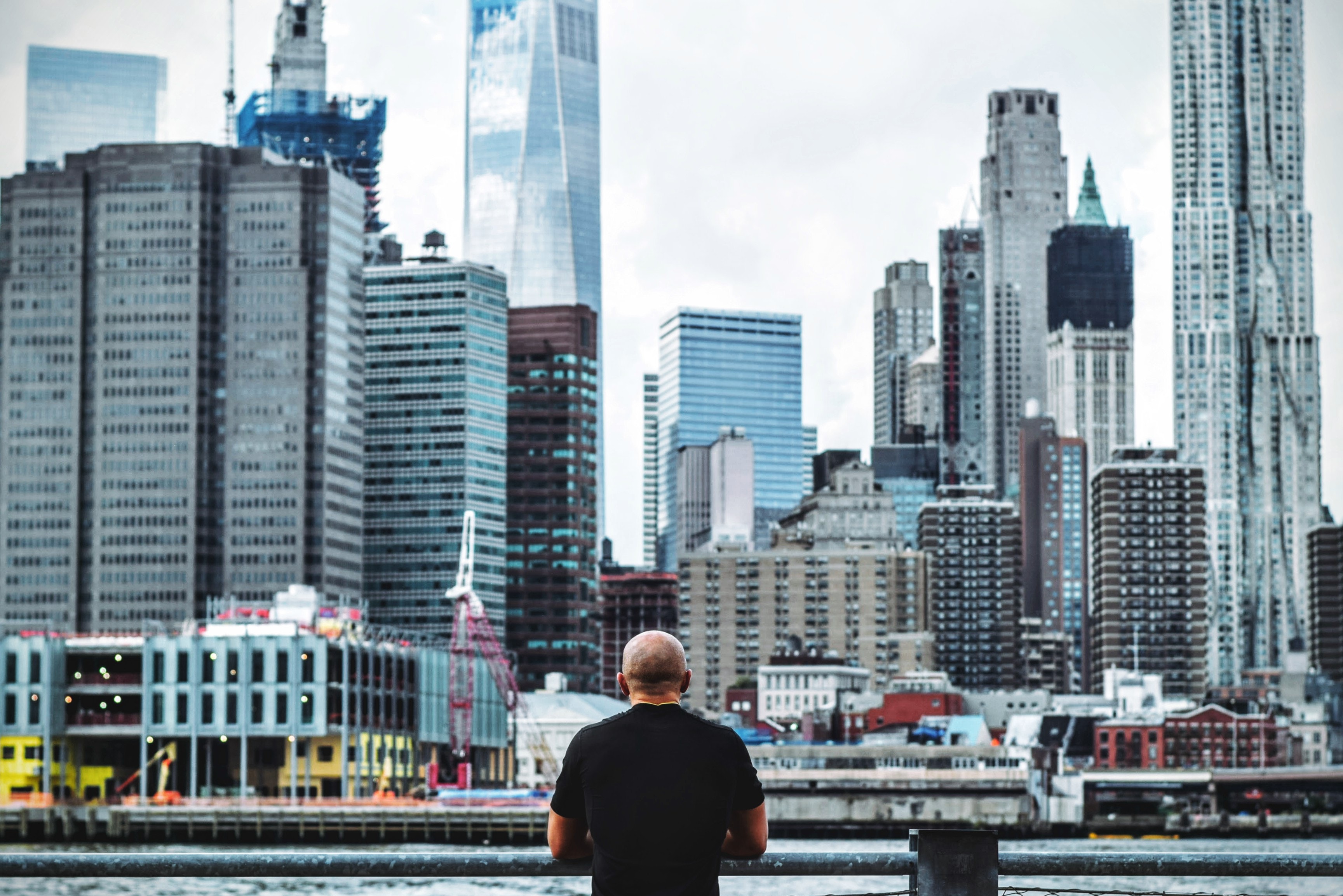Man in black t shirt in front on city skyline during daytime photo