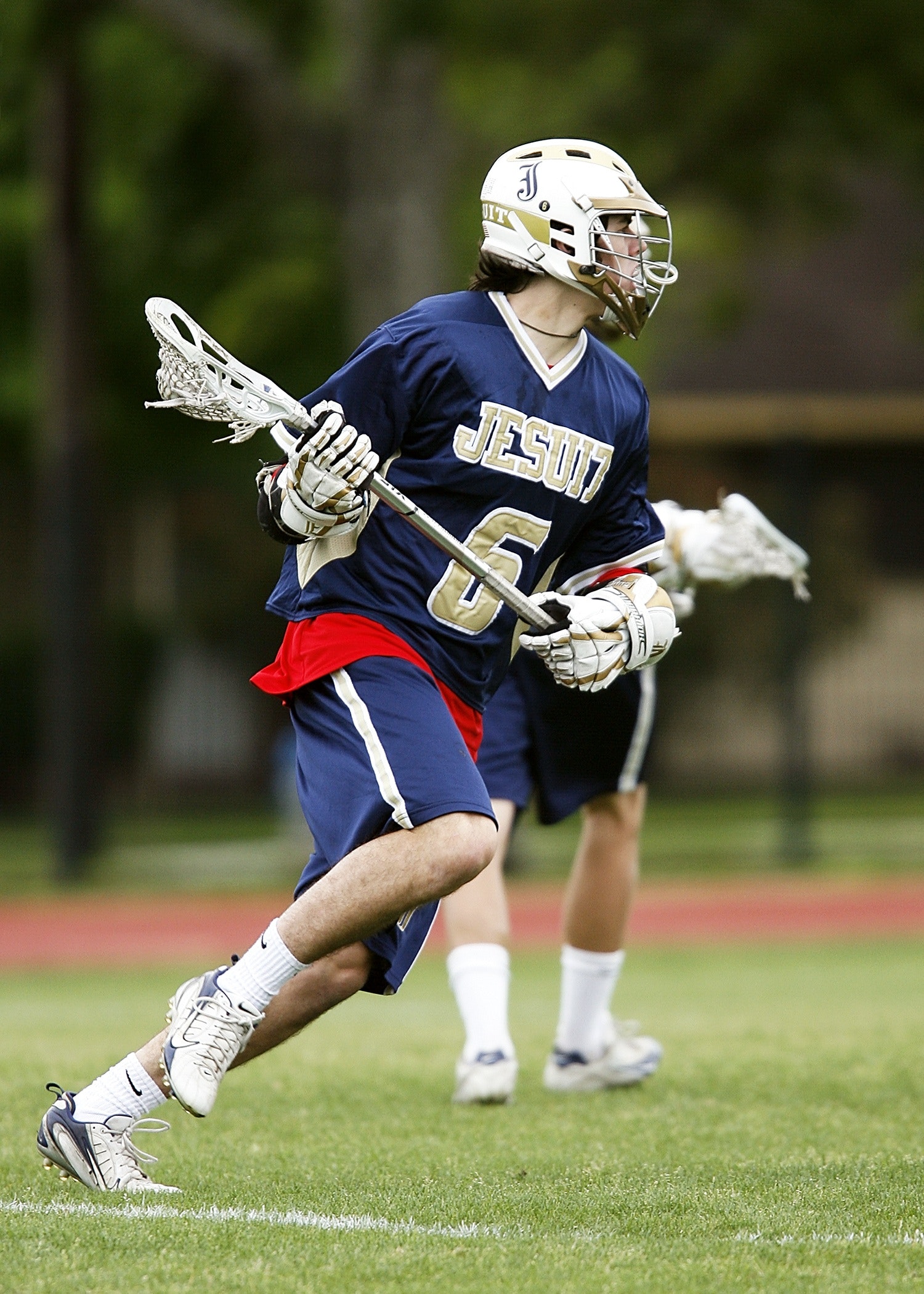 Man in blue and white jersey playing lacrosse photo