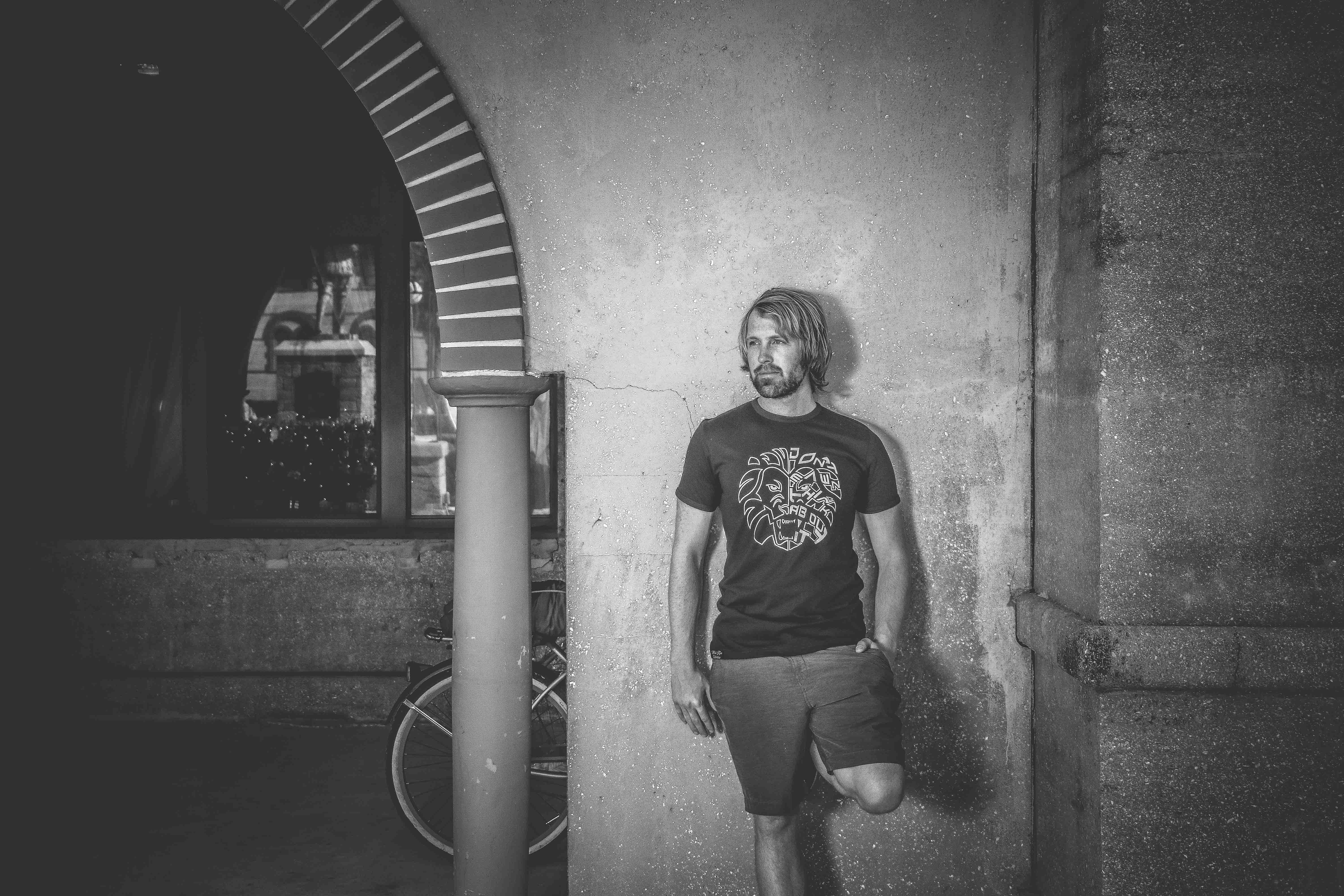 Man in Crew-neck T-shirt and Shorts Leaning on Wall, Arch, Bicycle, Black and white, Column, HQ Photo
