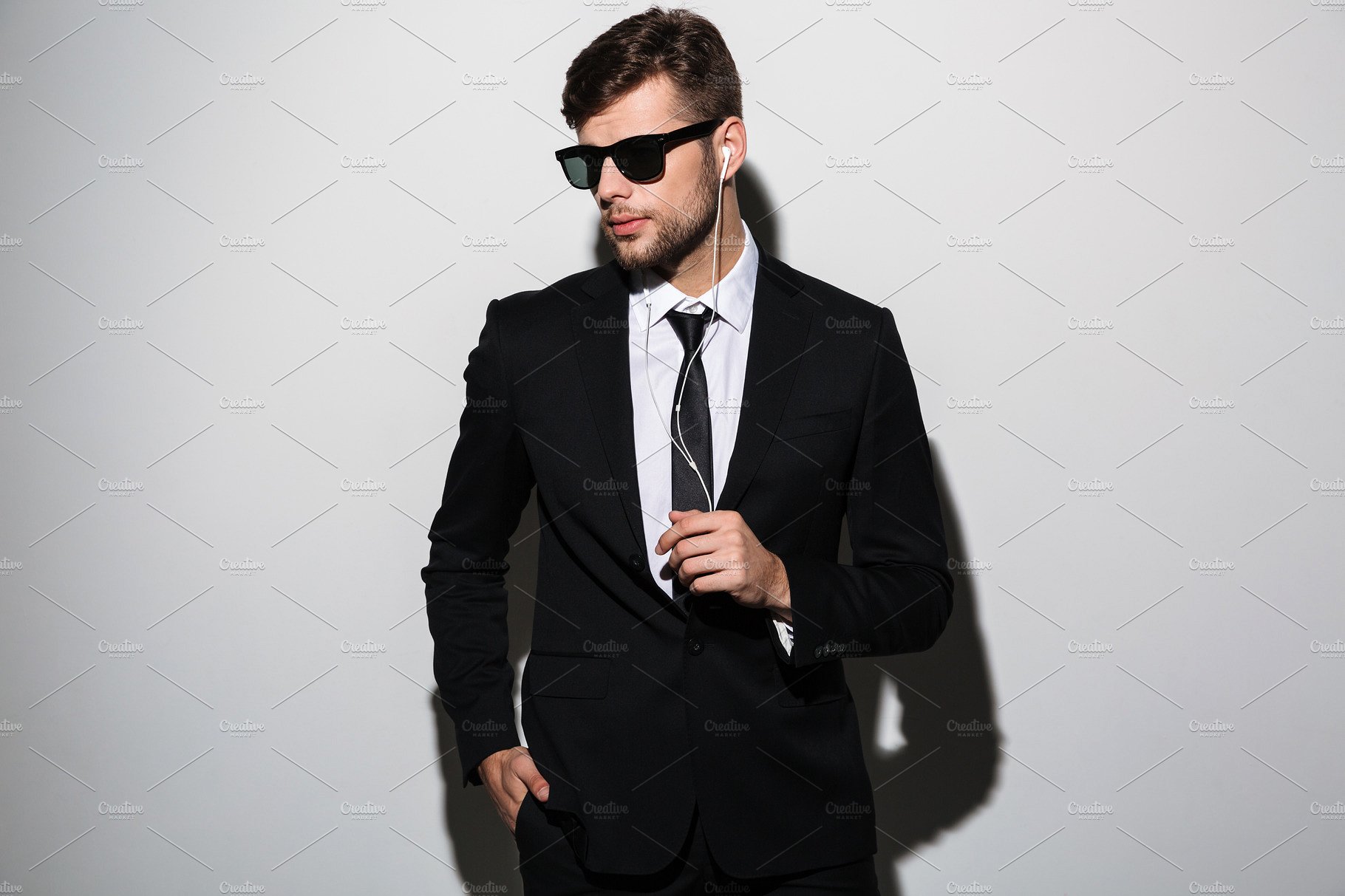 Portrait of a handsome stylish man in suit ~ Business Photos ...