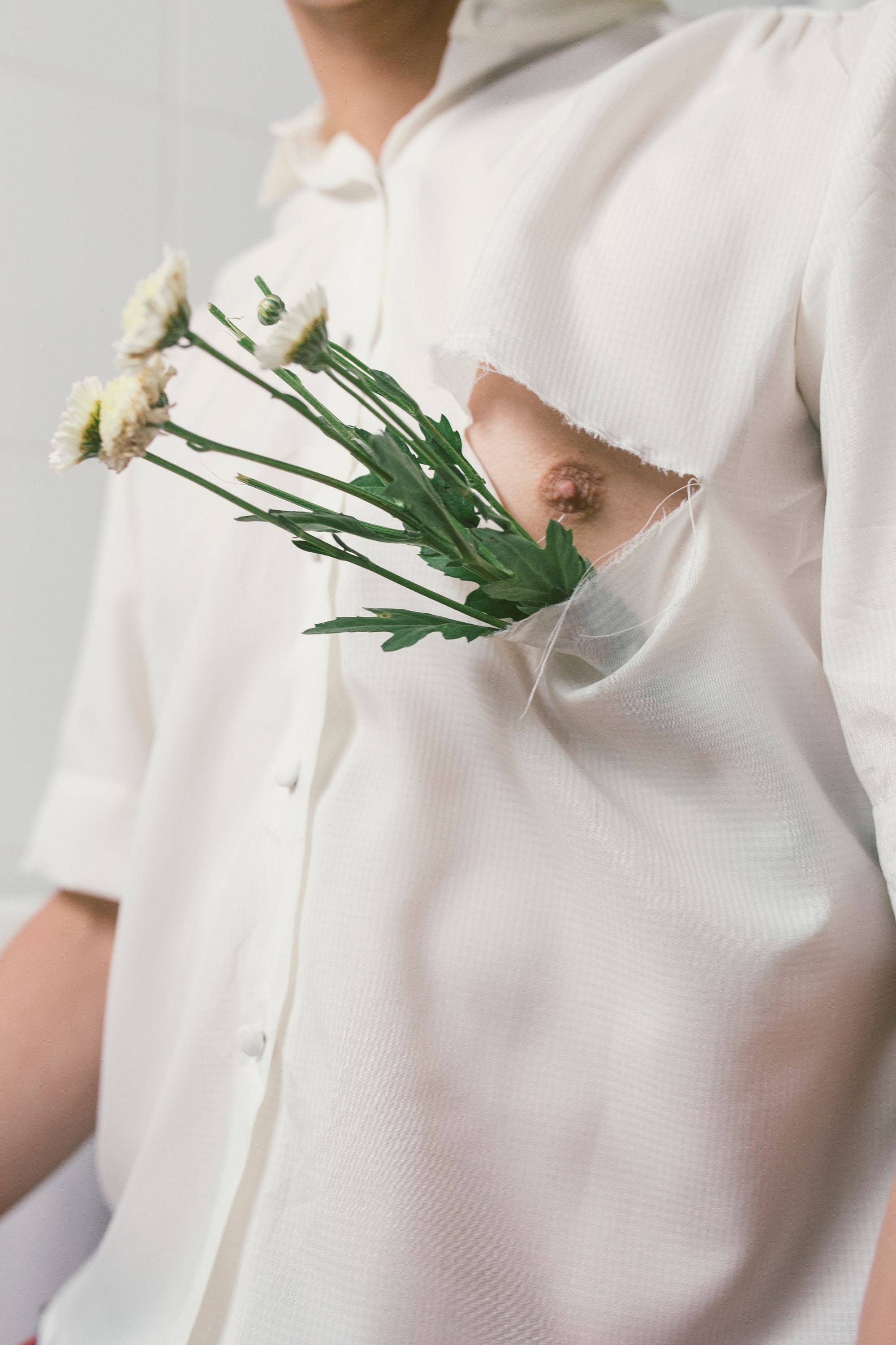 Man in white button-up shirt with white flowers photo