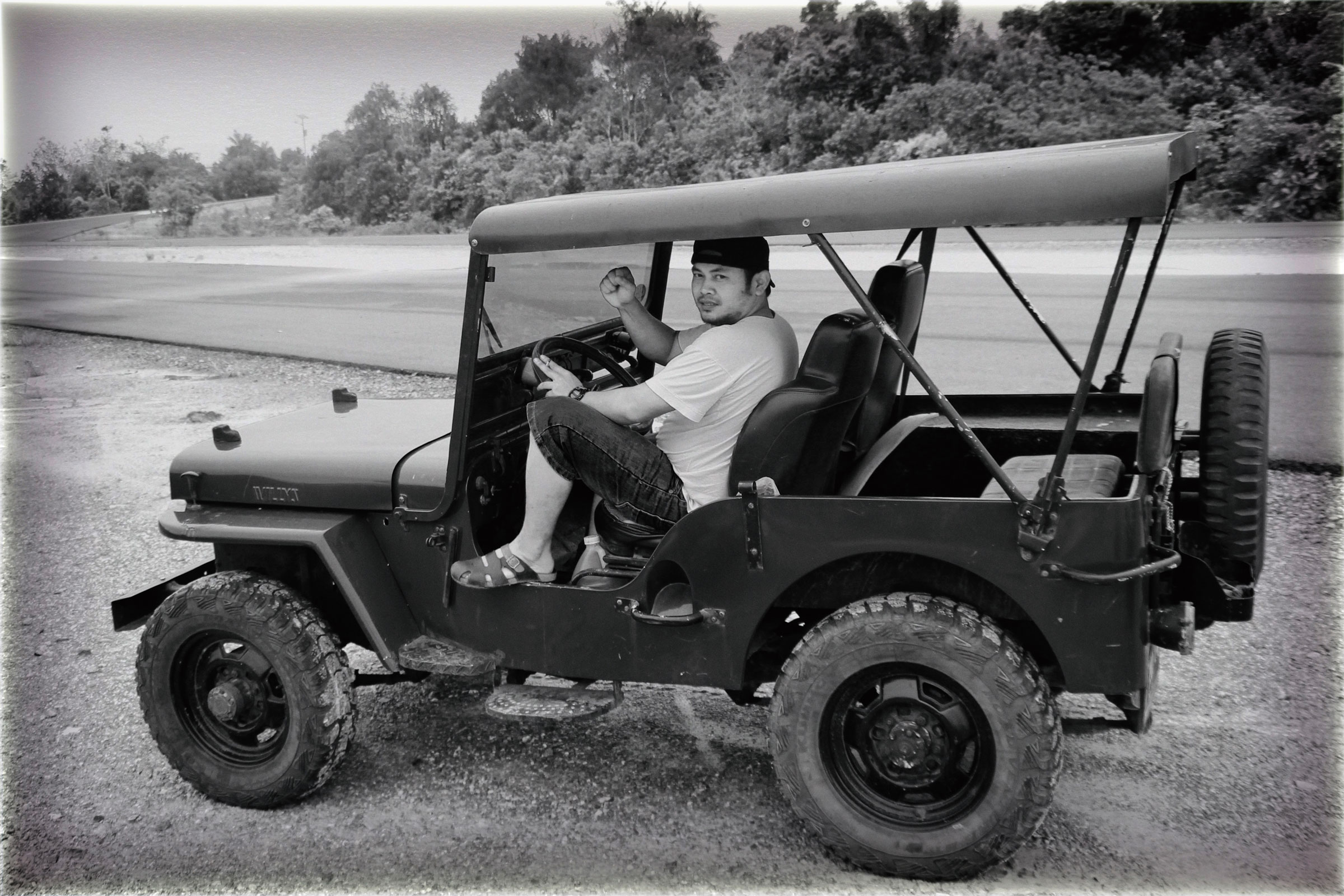 Man in willy's jeep photo