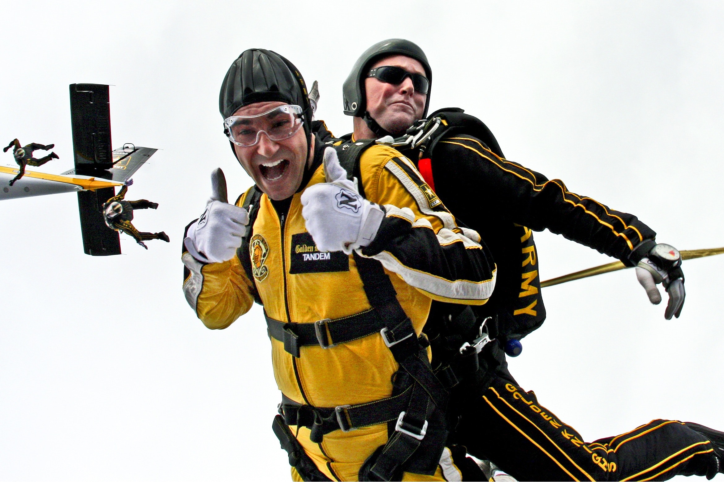 Man in yellow jumpsuit and man in black jumpsuit sky diving photo