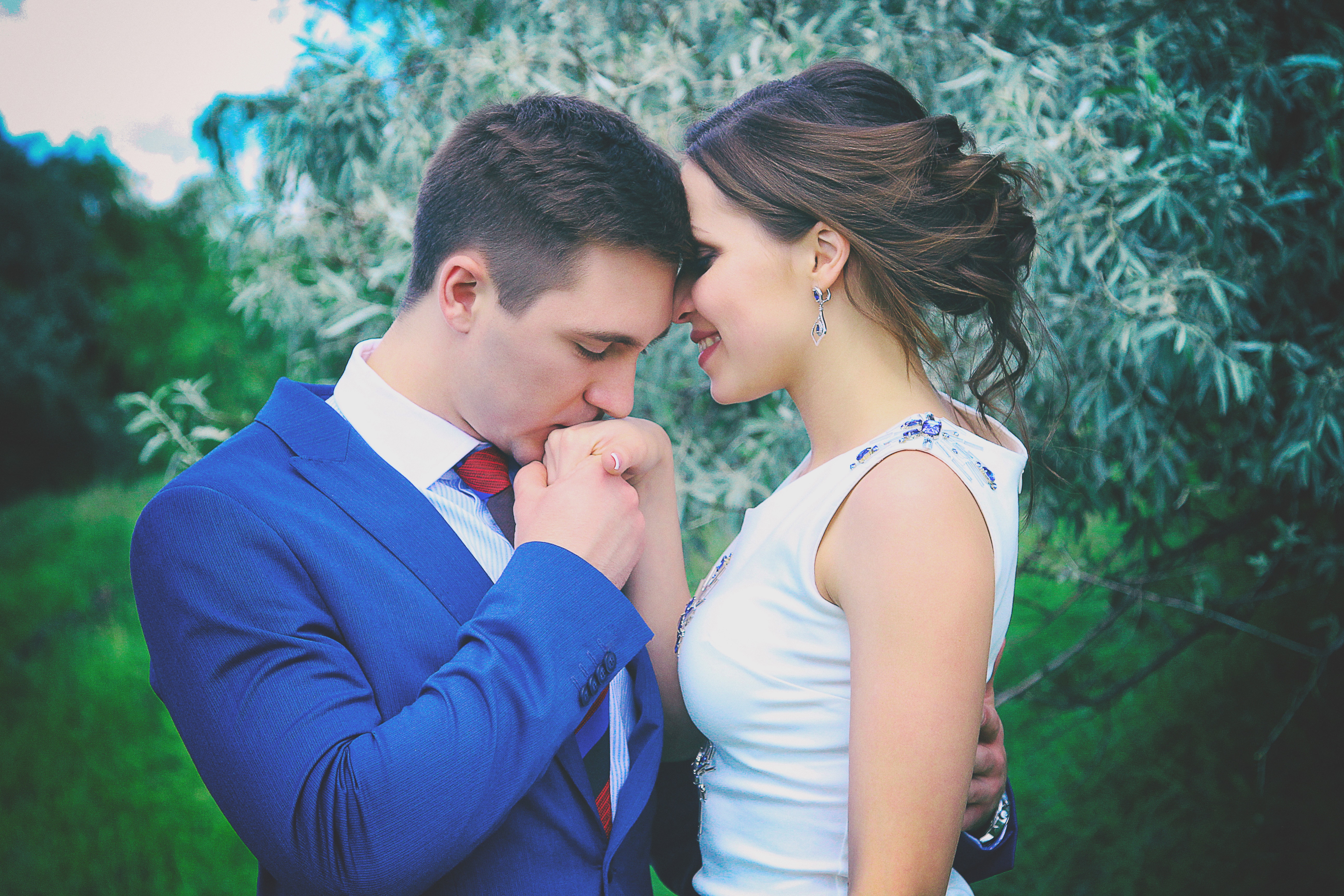 Man kissing woman's right hand photo