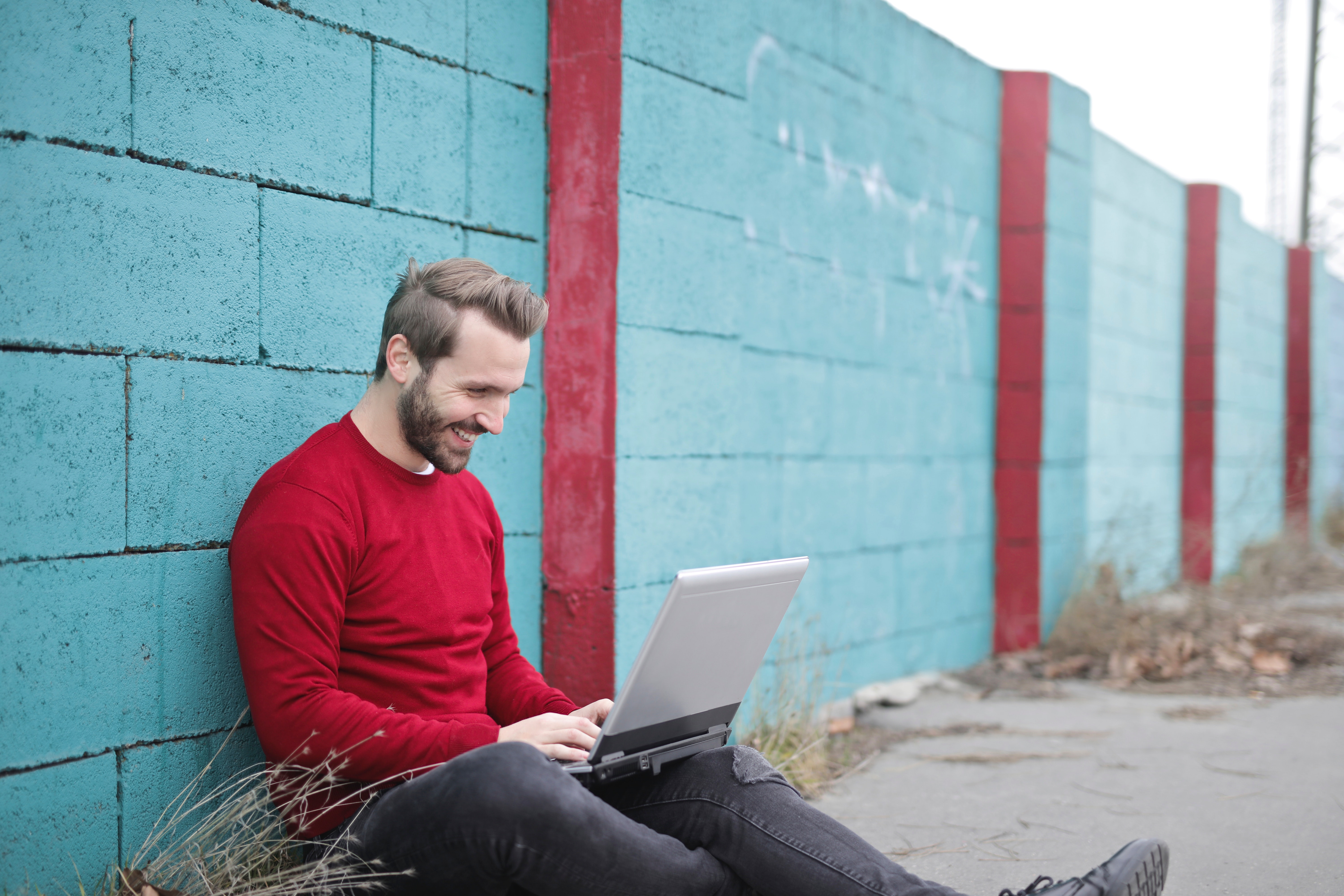 Man Leaning Against Wall Using Laptop, Notebook, Wall, Urban, Technology, HQ Photo