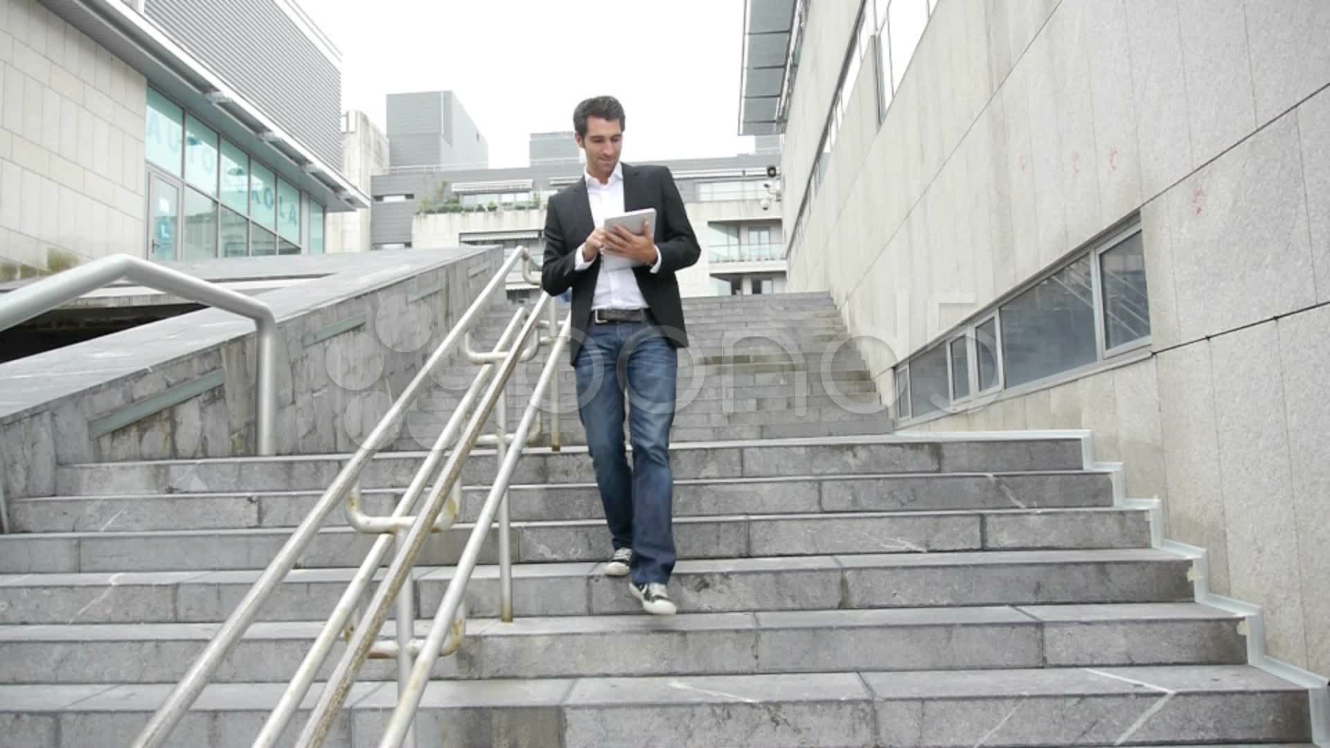 Man walking down stairs with tablet ~ Hi Res Video #14830136