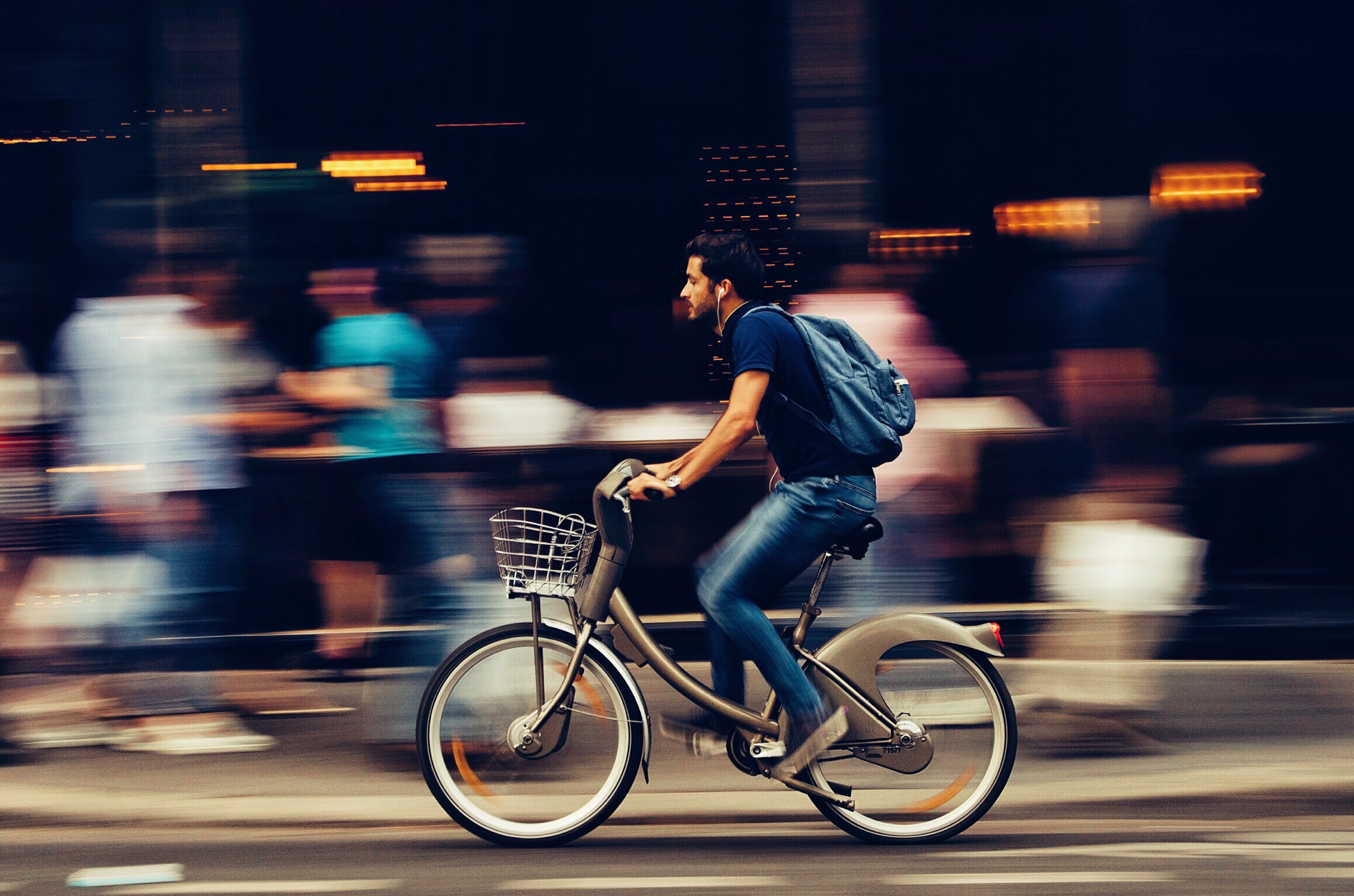 Man riding bicycle on city street photo