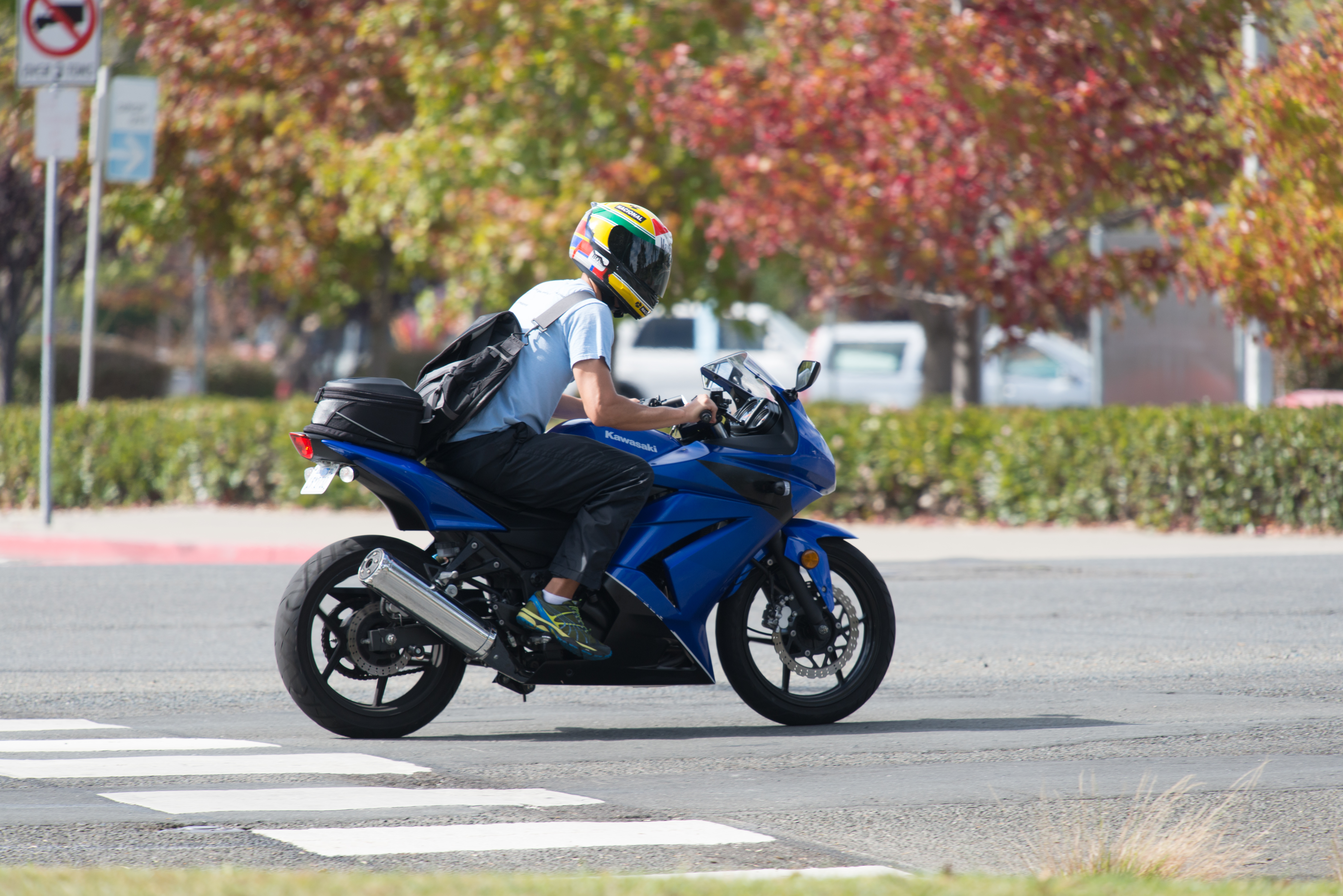 Man riding blue kawasaki ninja 250r in road photo