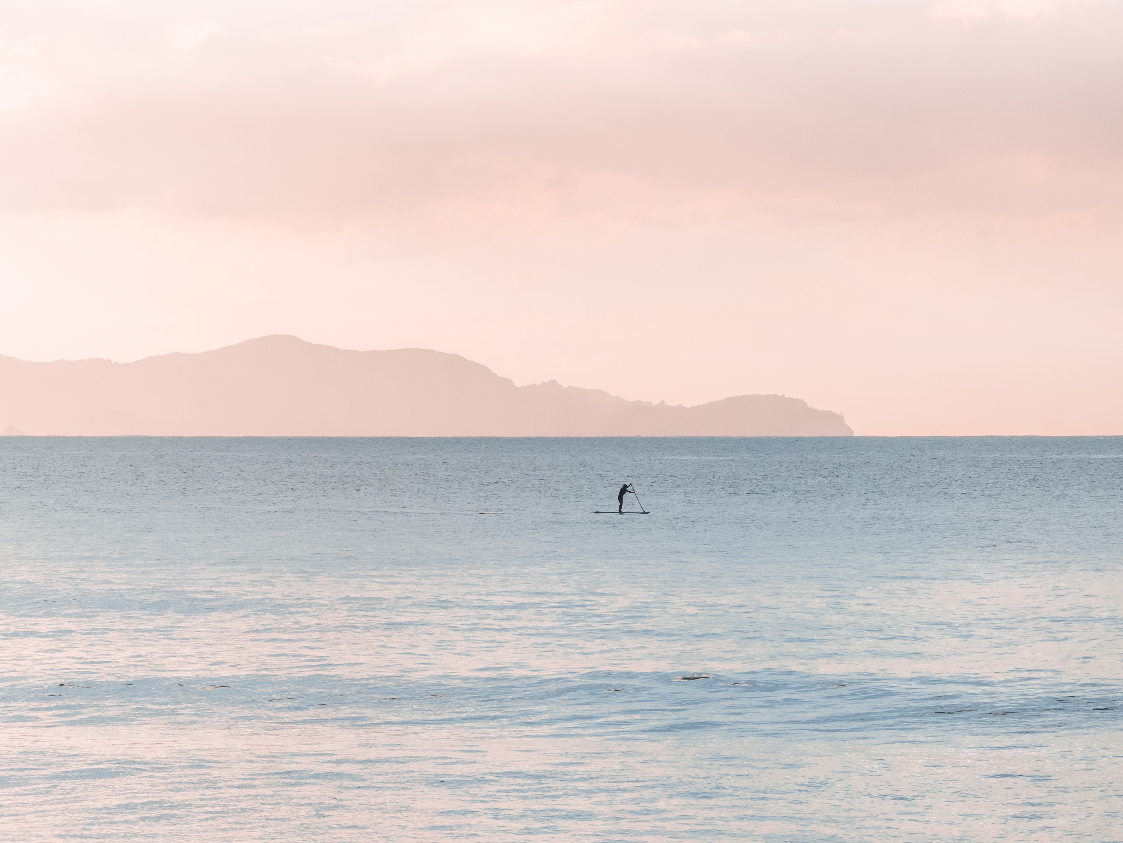 Man rowing a boat on sea at daytime photo