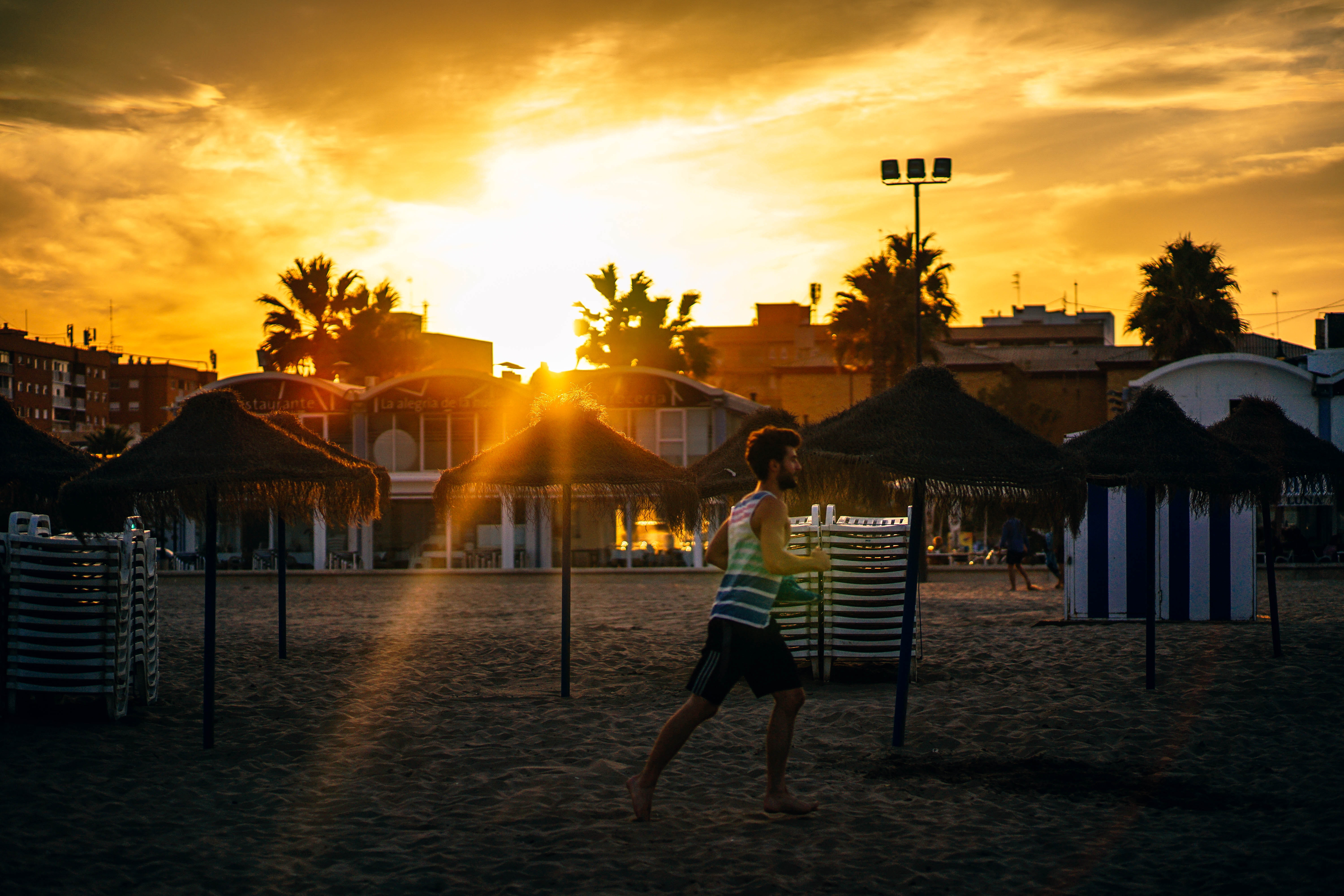 Man running in the beach during sunset photo