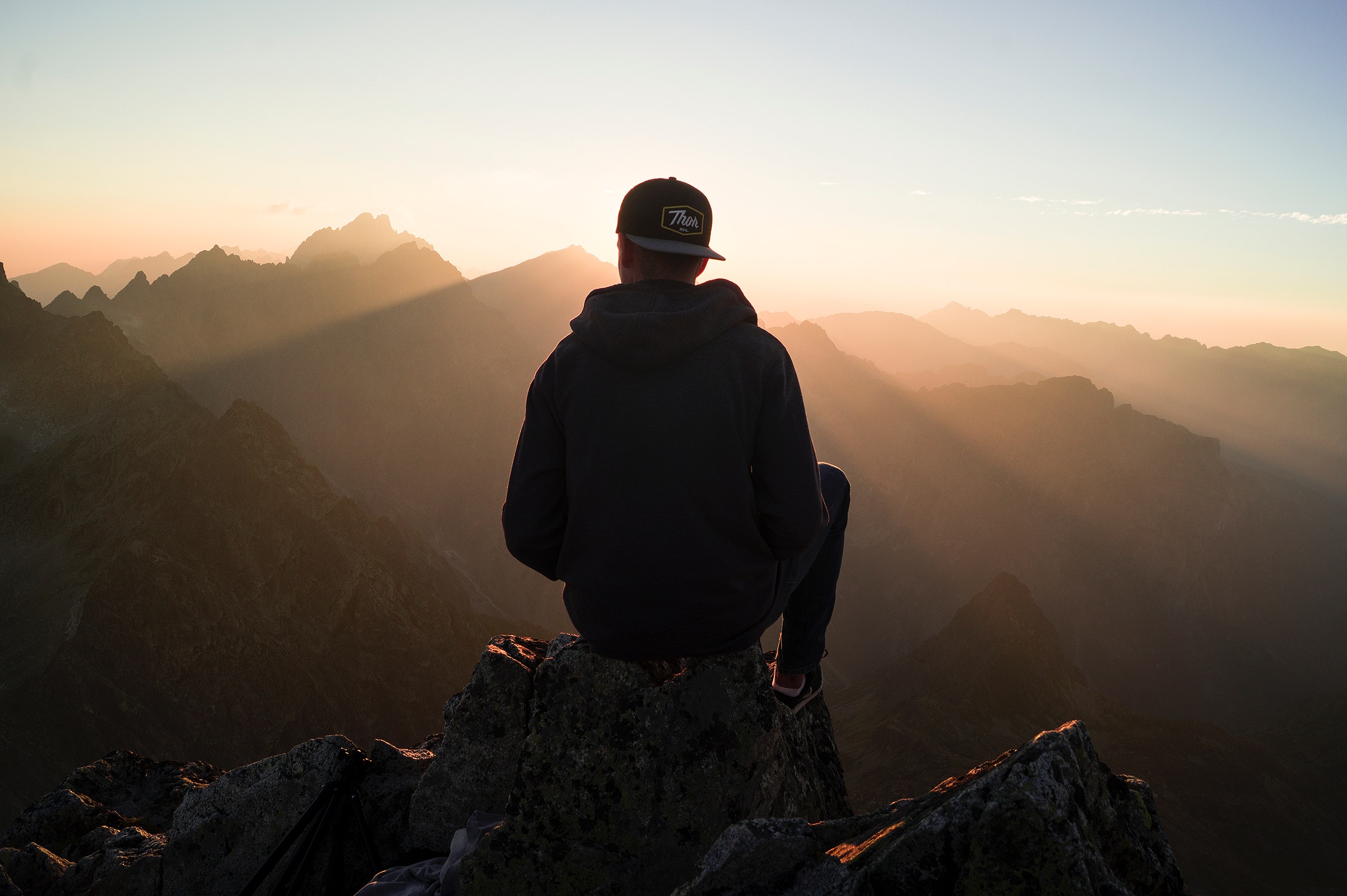 Man sitting on the mountain edge photo