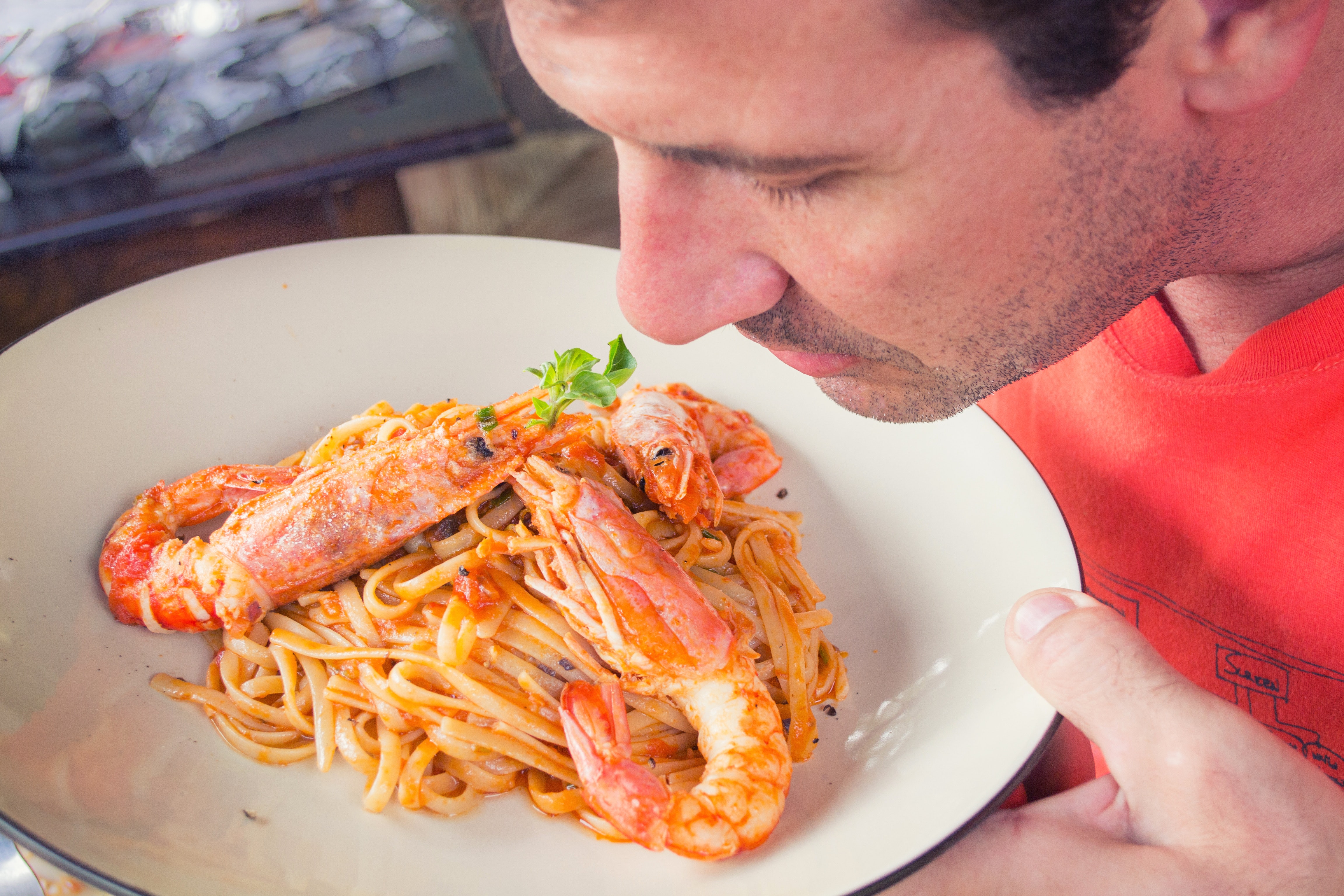 Man Smelling Prawn and Pasta Dish on White Ceramic Plate, Meal, Spaghetti, Smelling, Shrimps, HQ Photo