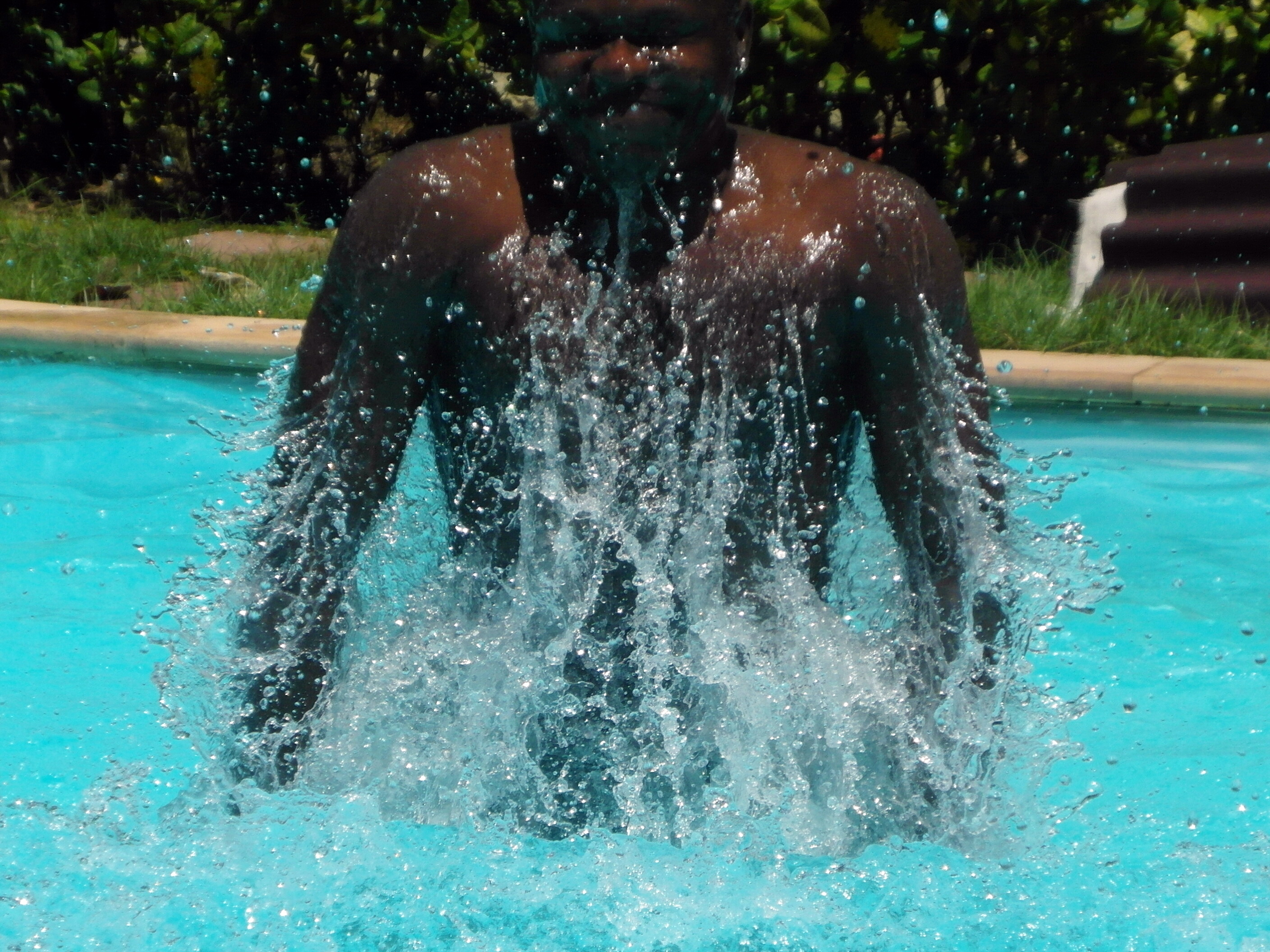 Man splashing in the swimming pool photo