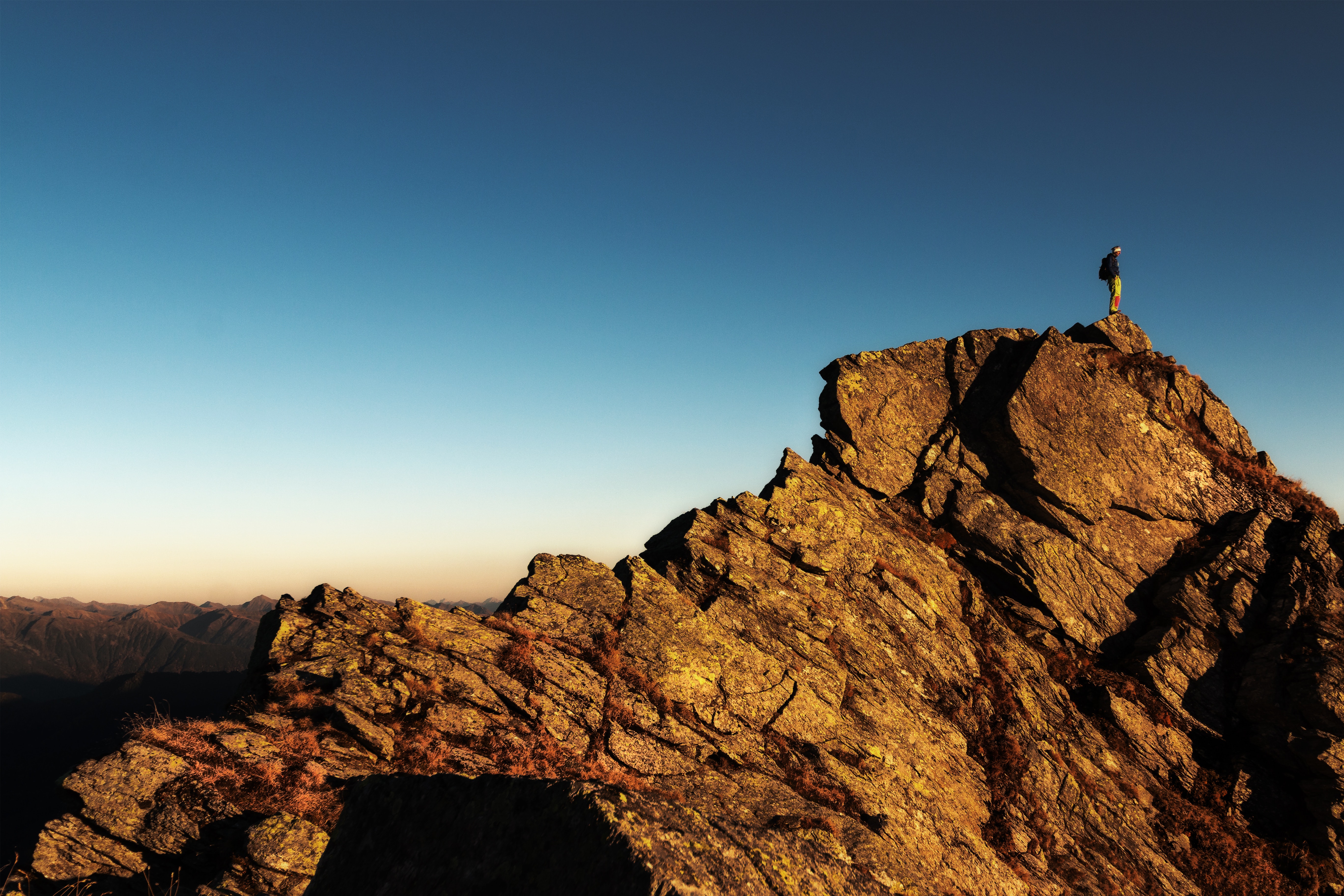 Man standing on top of rock at daytime photo