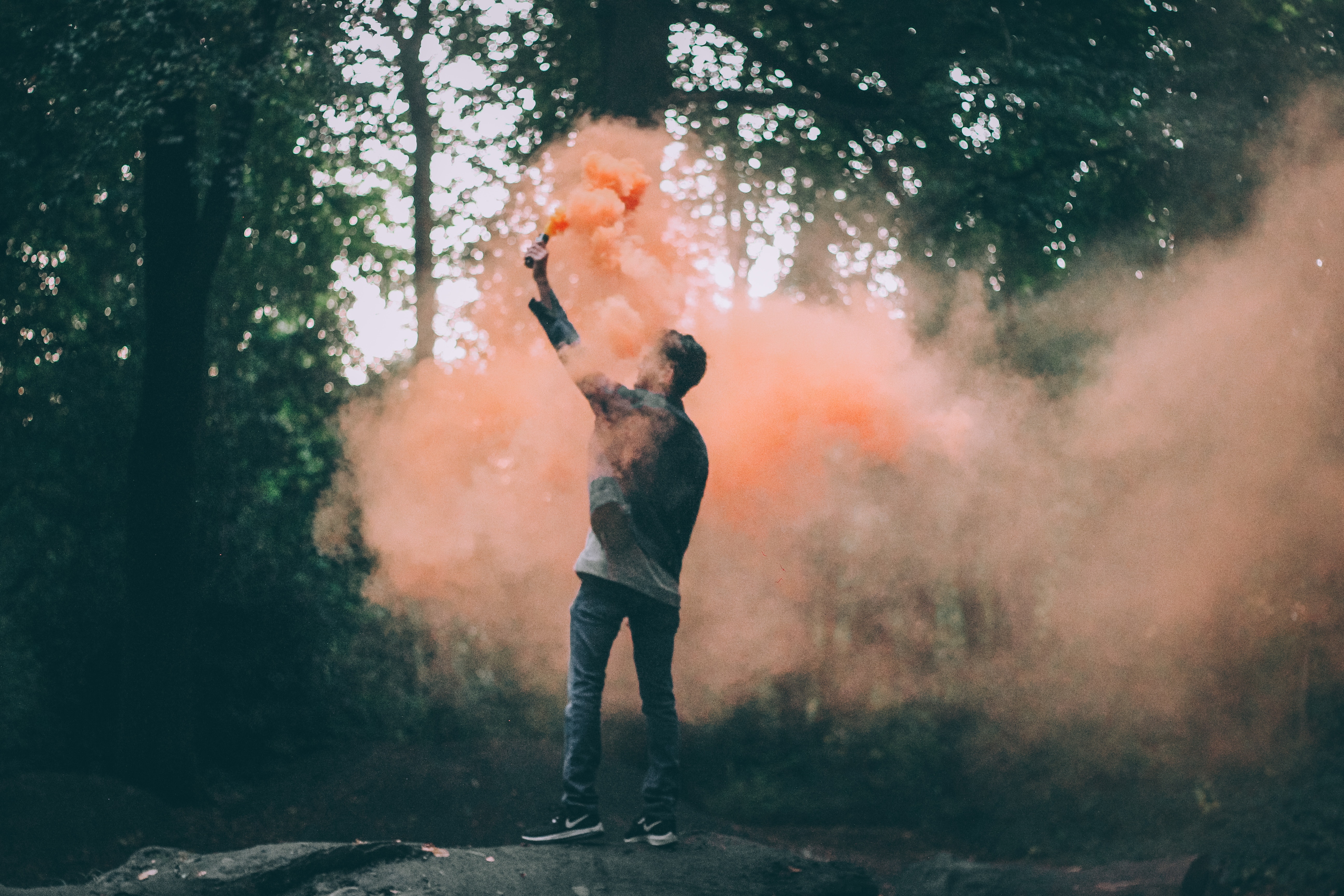 Man throwing peach-colored powder photo