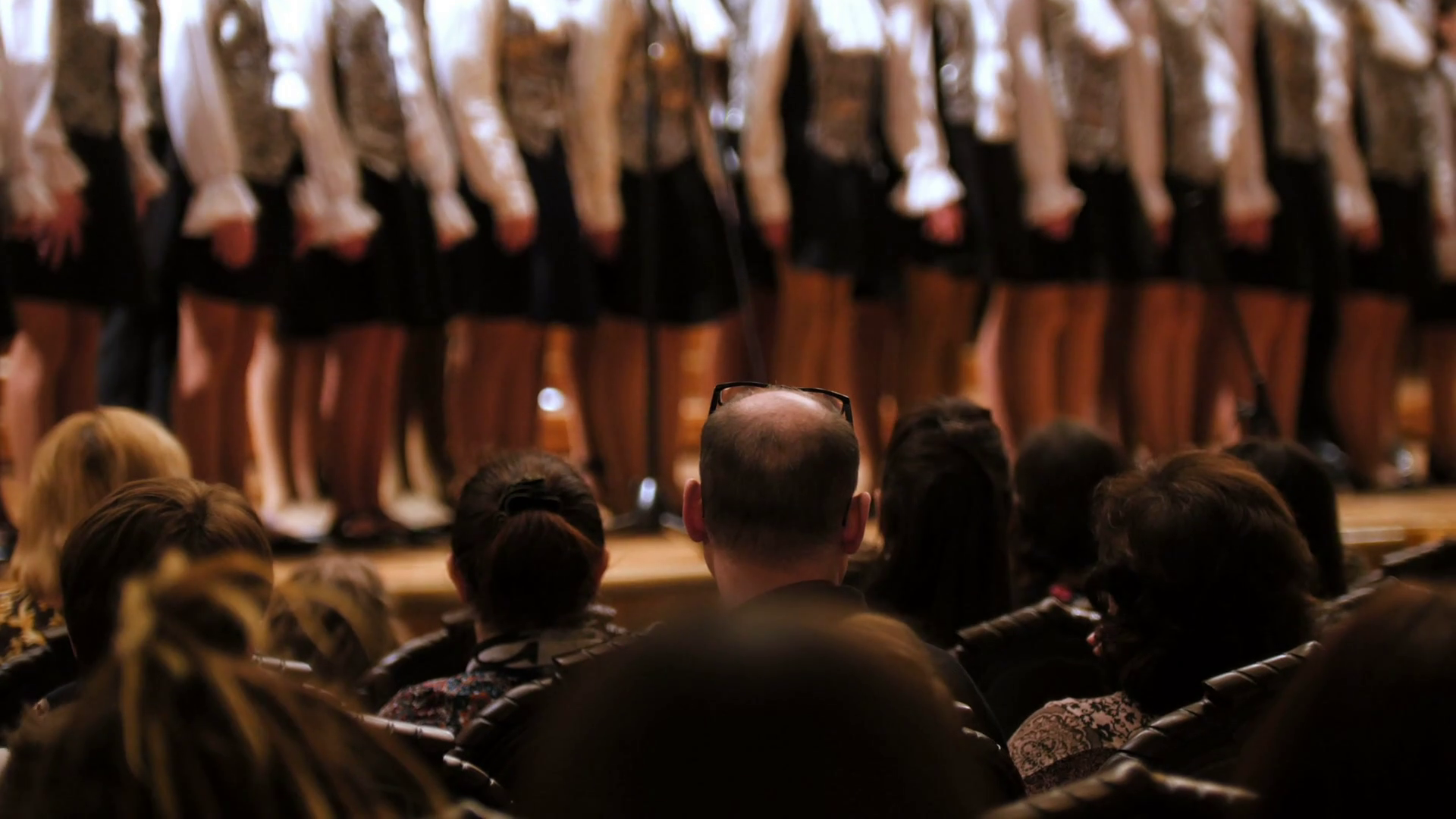 Spectators in concert hall - bald man watching choir of children ...