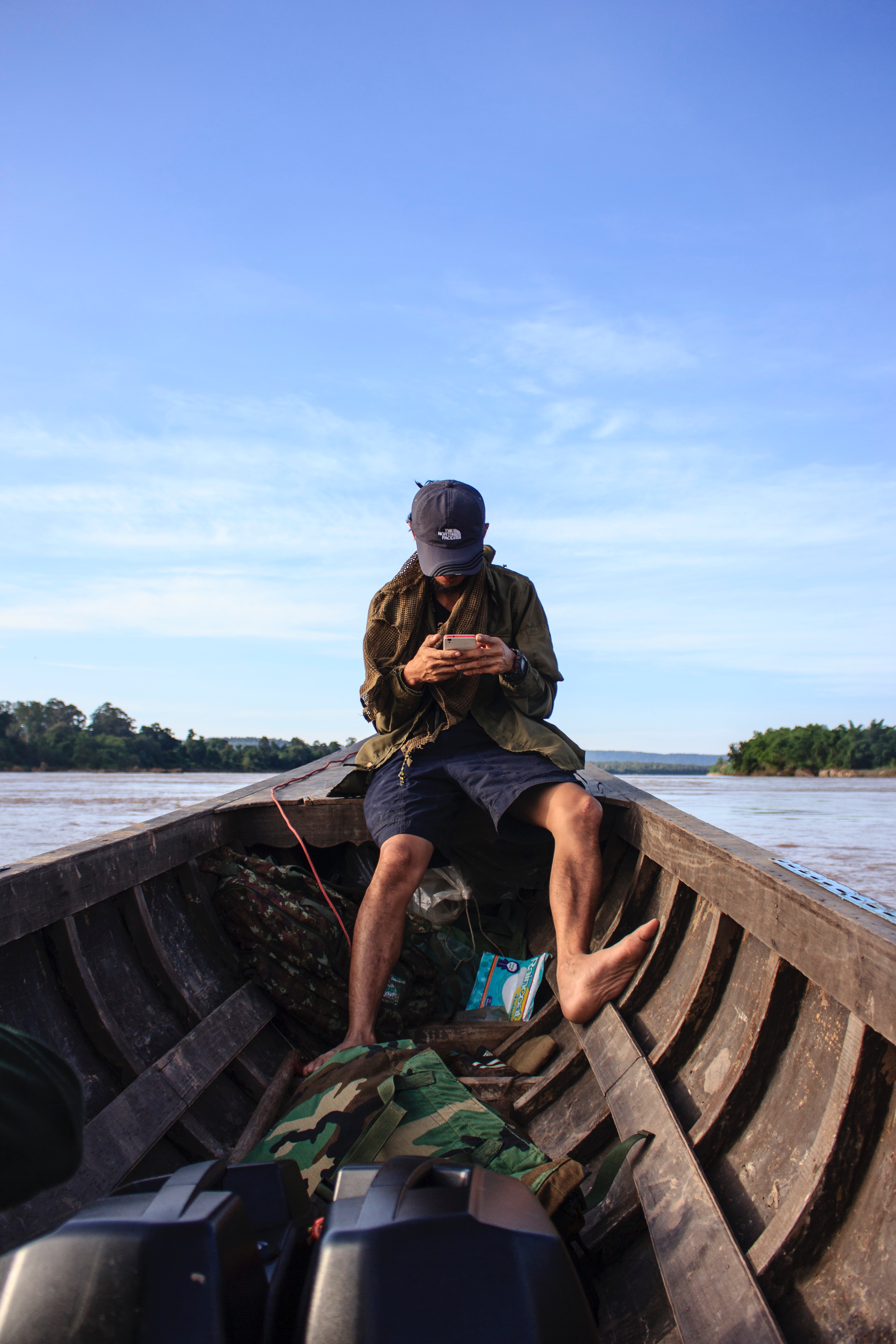Man wearing black cap sitting inside a boat photo
