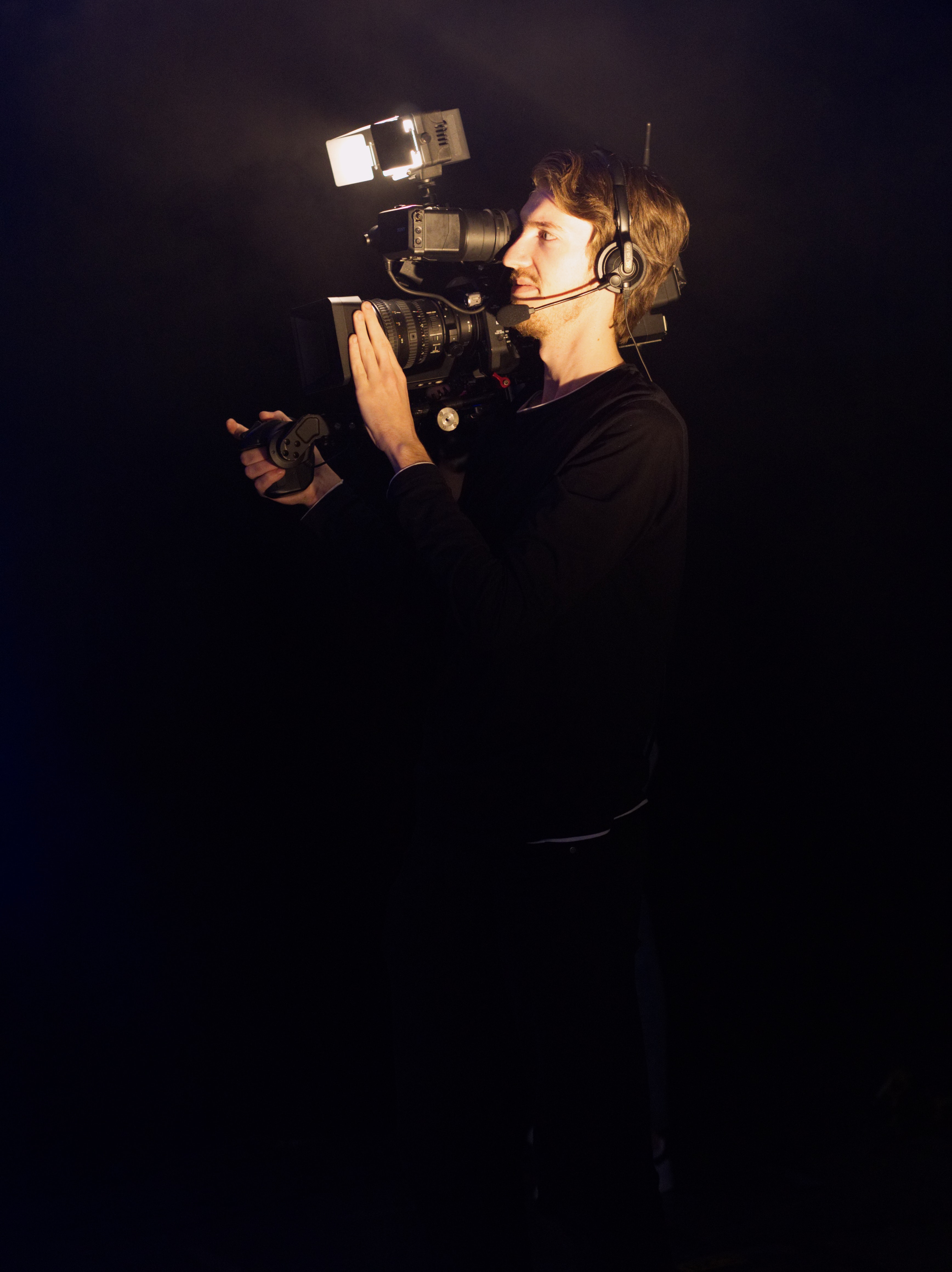 Man wearing black long-sleeved shirt using video camera photo