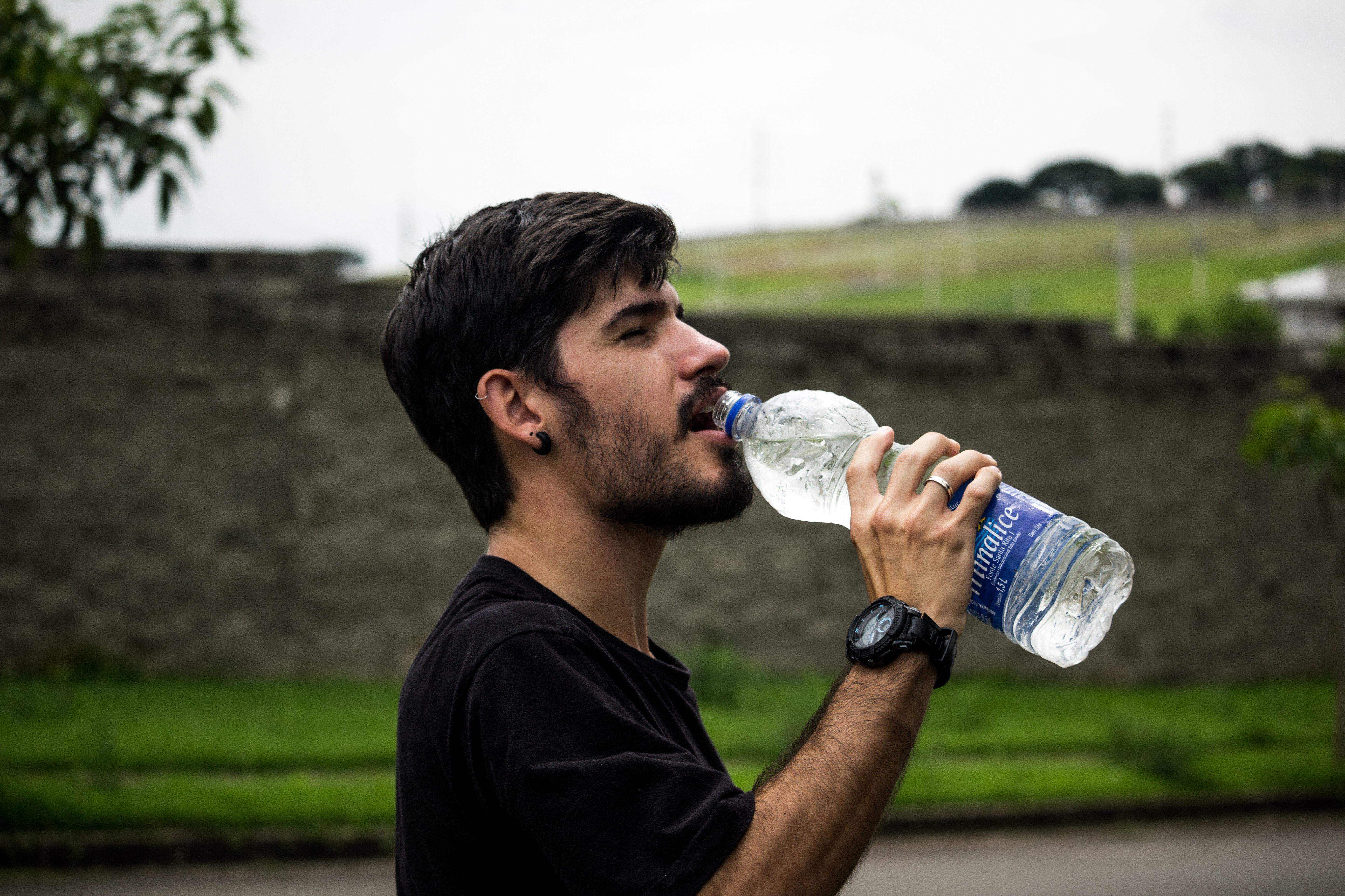 Man Wearing Black Shirt Drinking Water, Blurred background, Outdoors, Wrist watch, Wear, HQ Photo