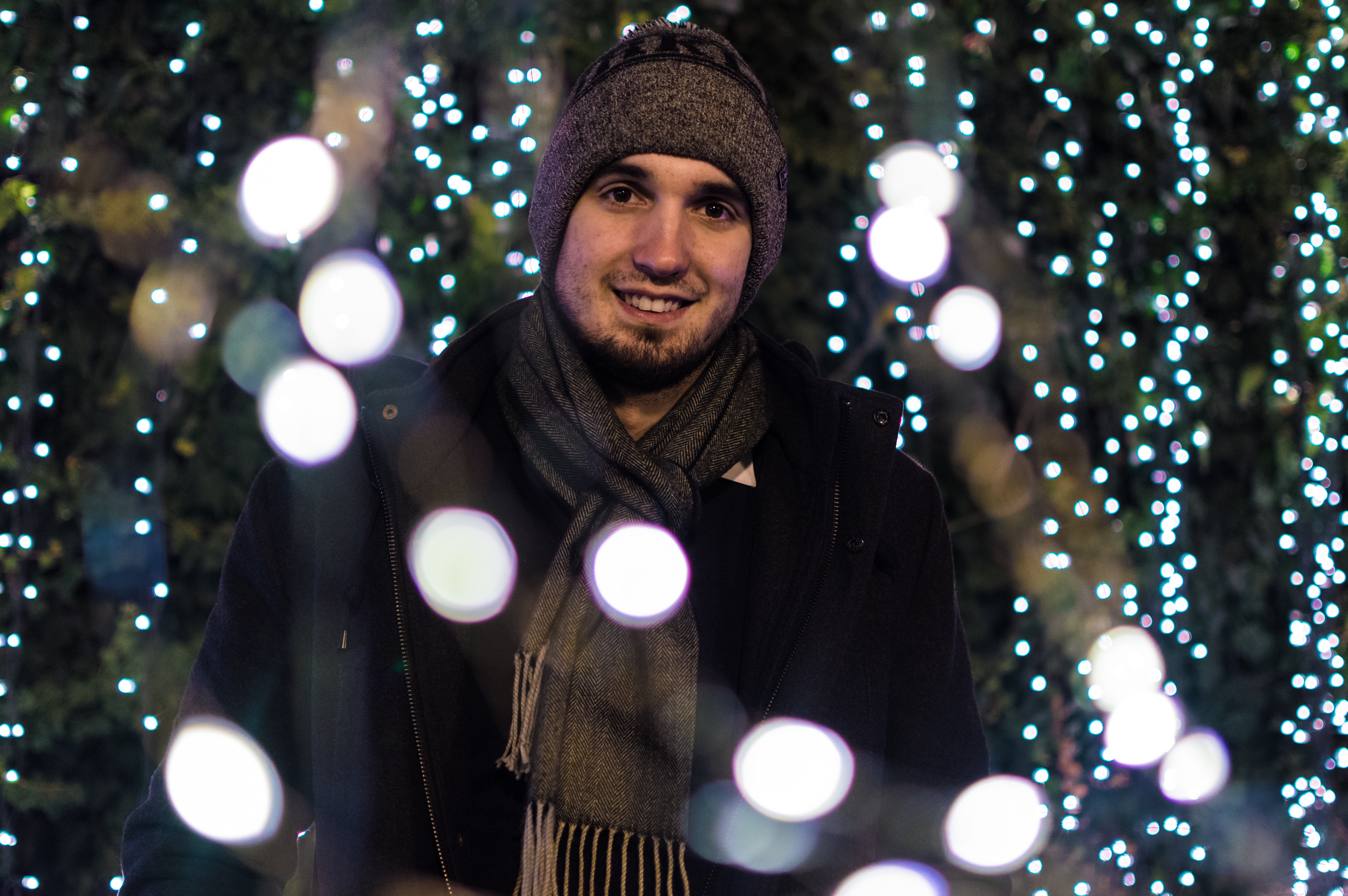 Man wearing snow coat with bokeh light background photo