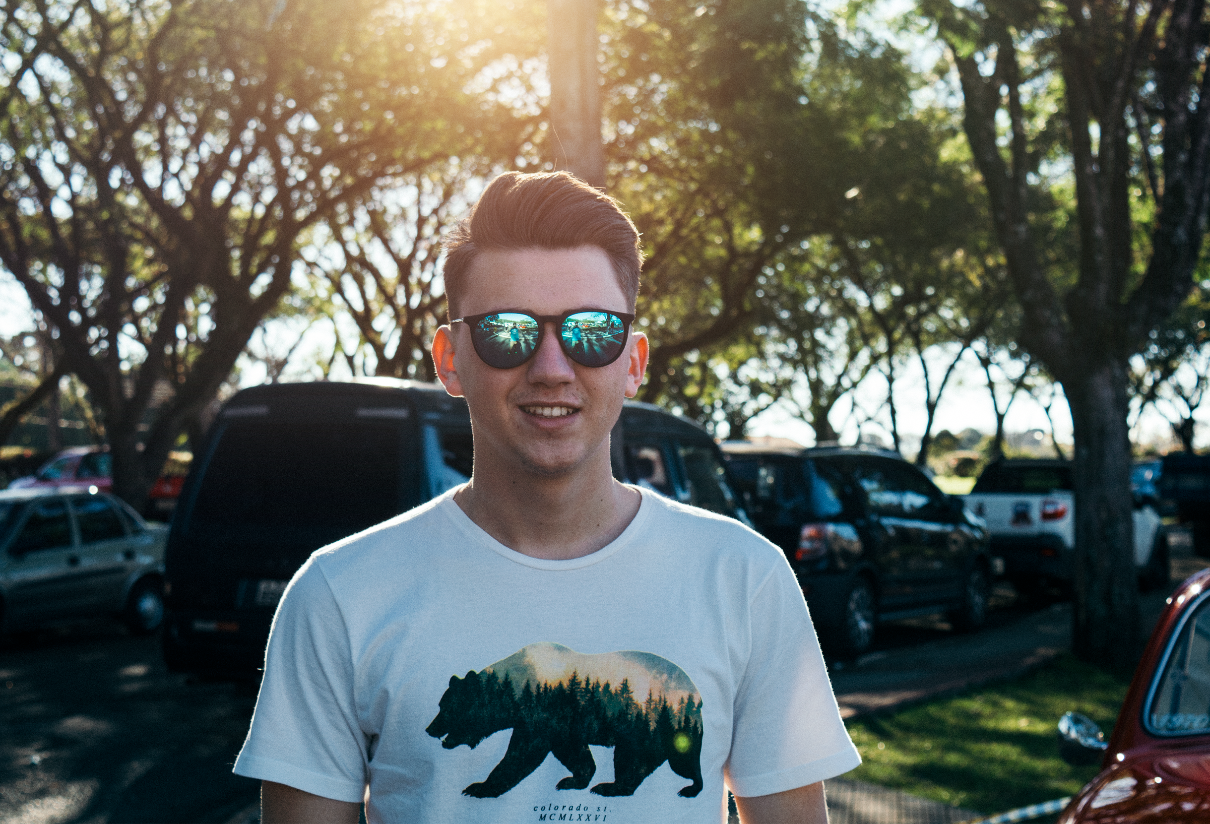Man wearing white and black bear printed shirt and sunglasses photo