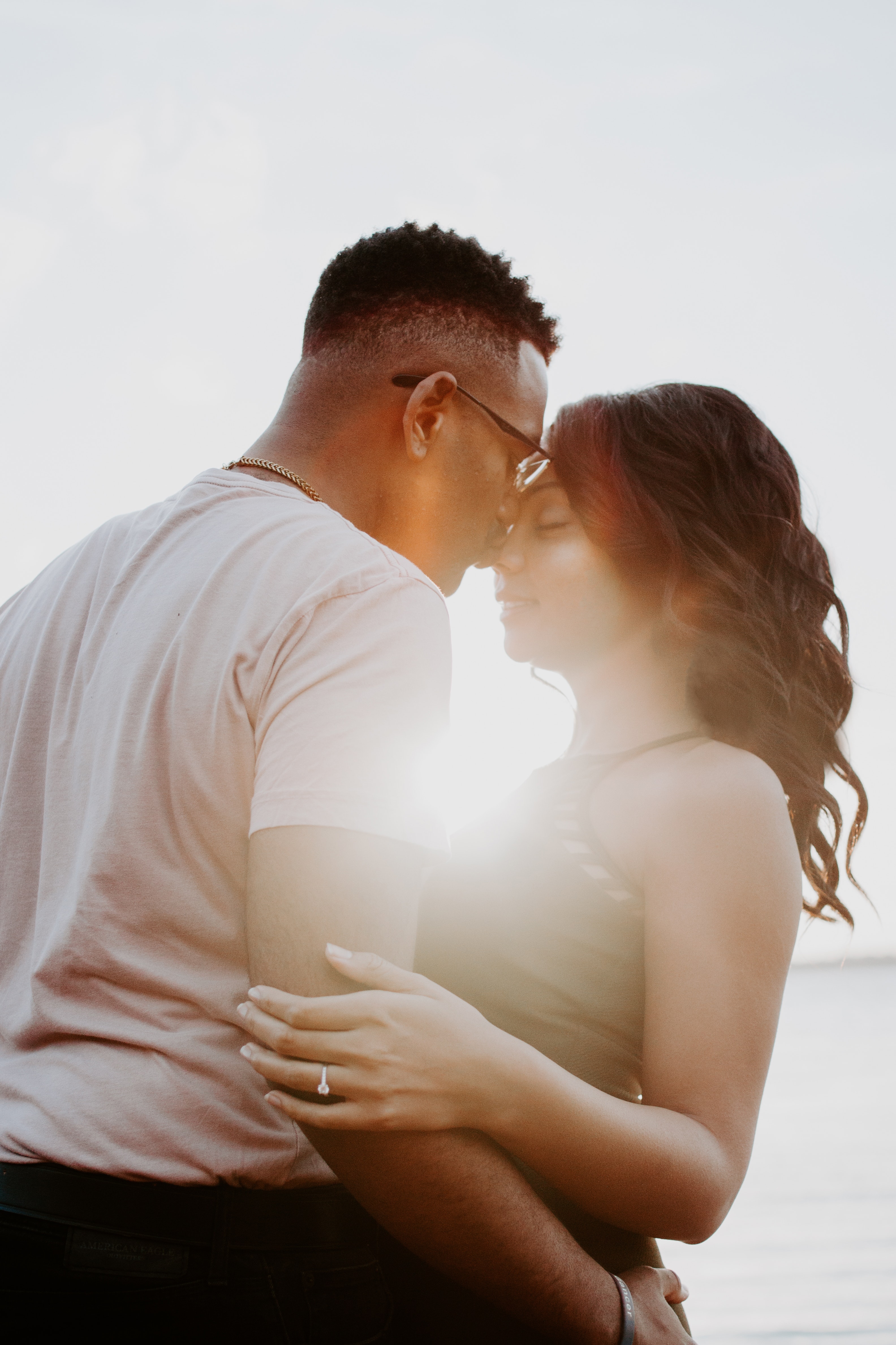 Man wearing white shirt kissing woman in her nose photo