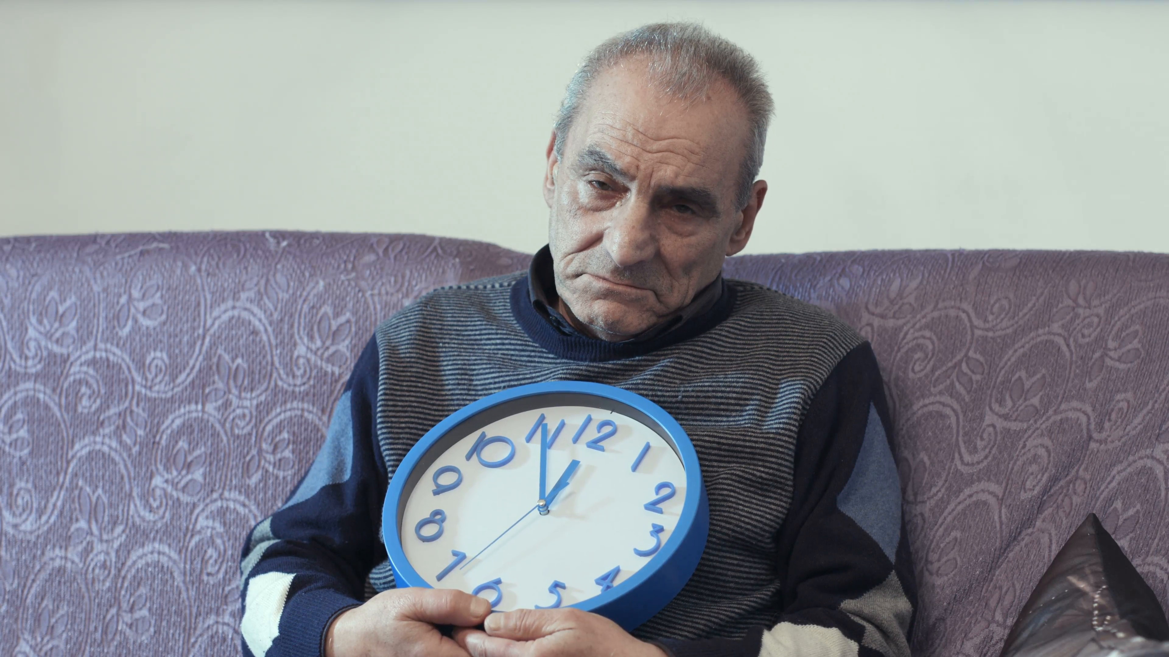 old man with a wall clock: time passing, time left, end of life ...