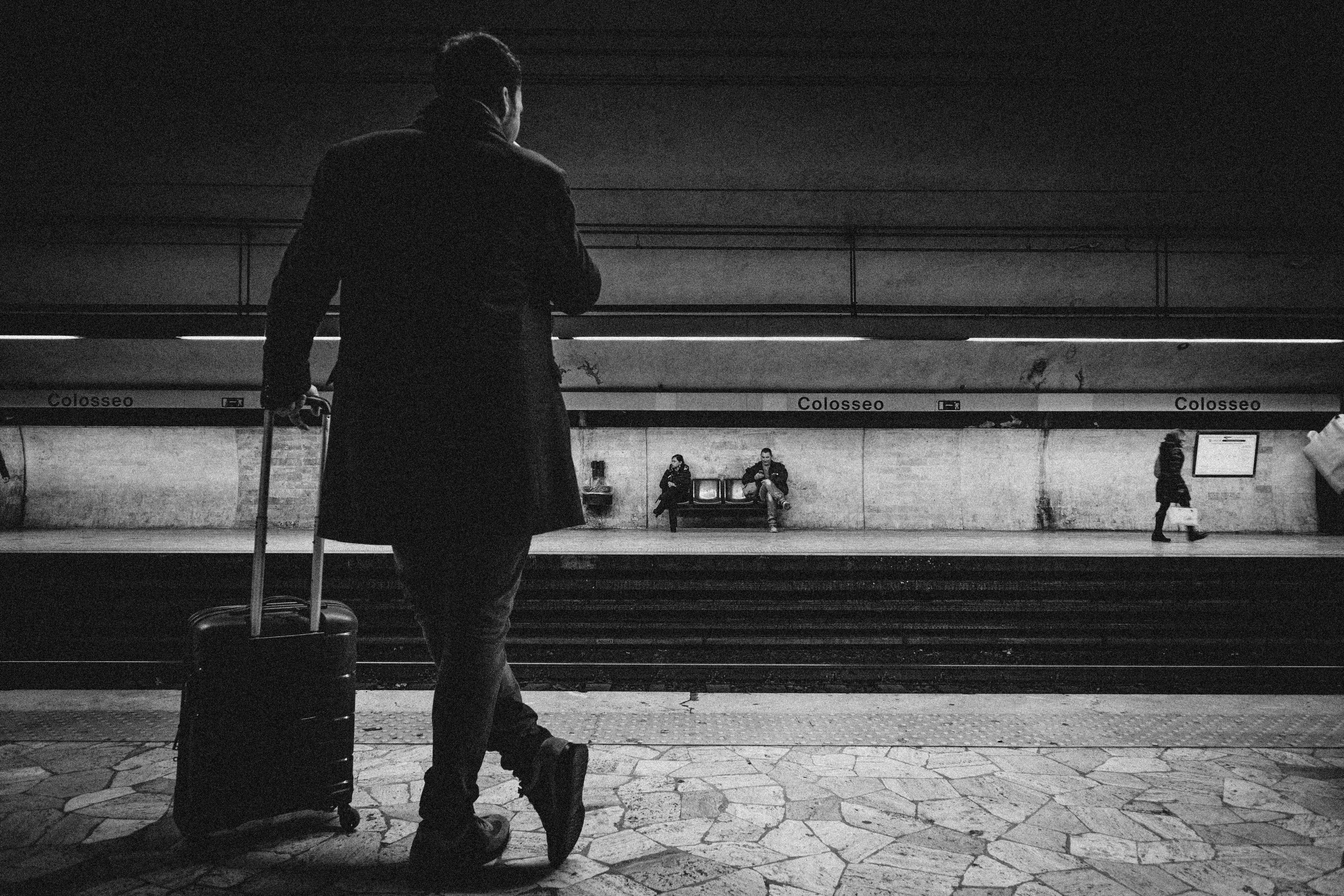 Man with luggage bag on train station photo