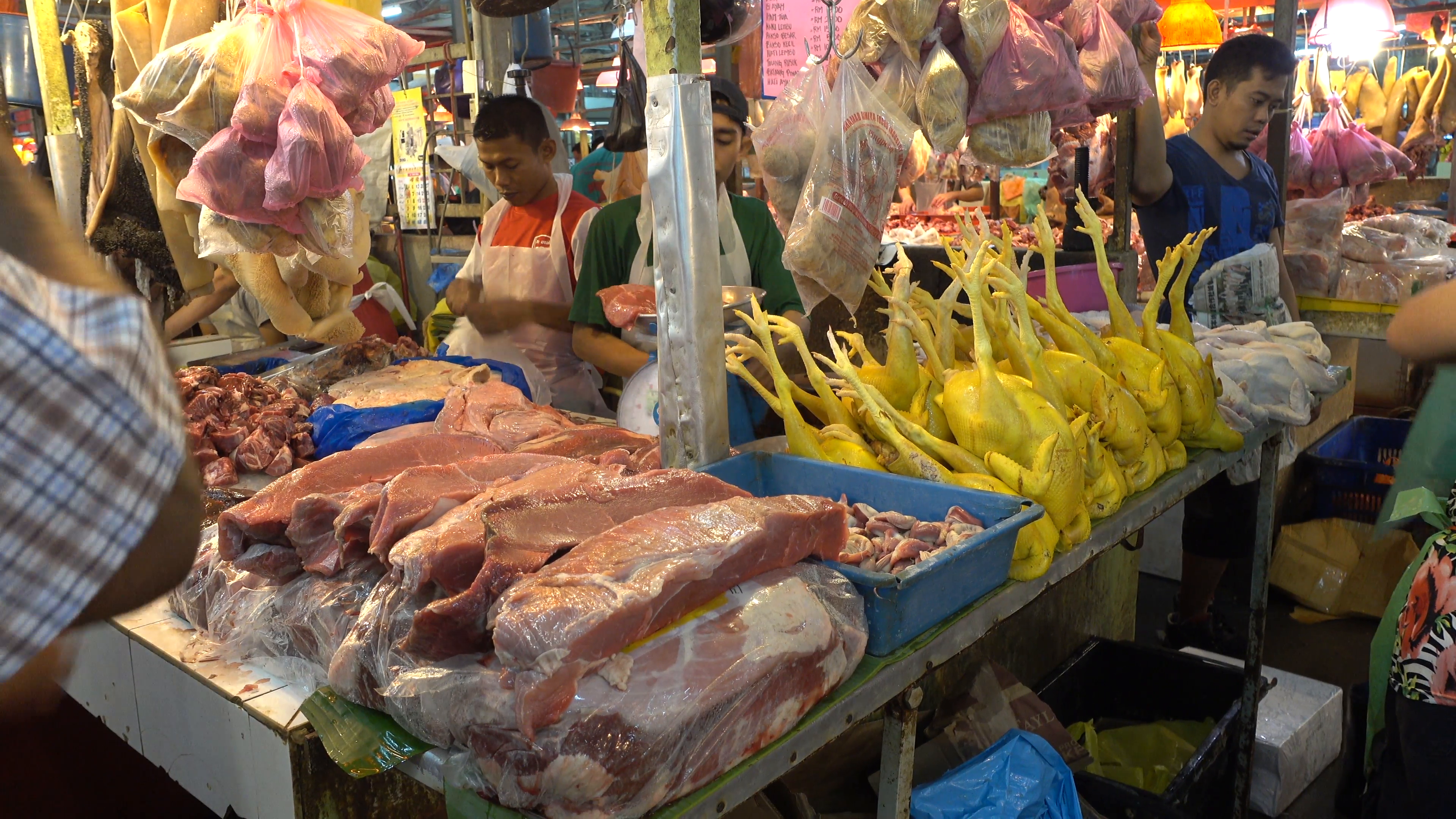 A scene of fishmonger and meat stalls at a wet market in the city ...