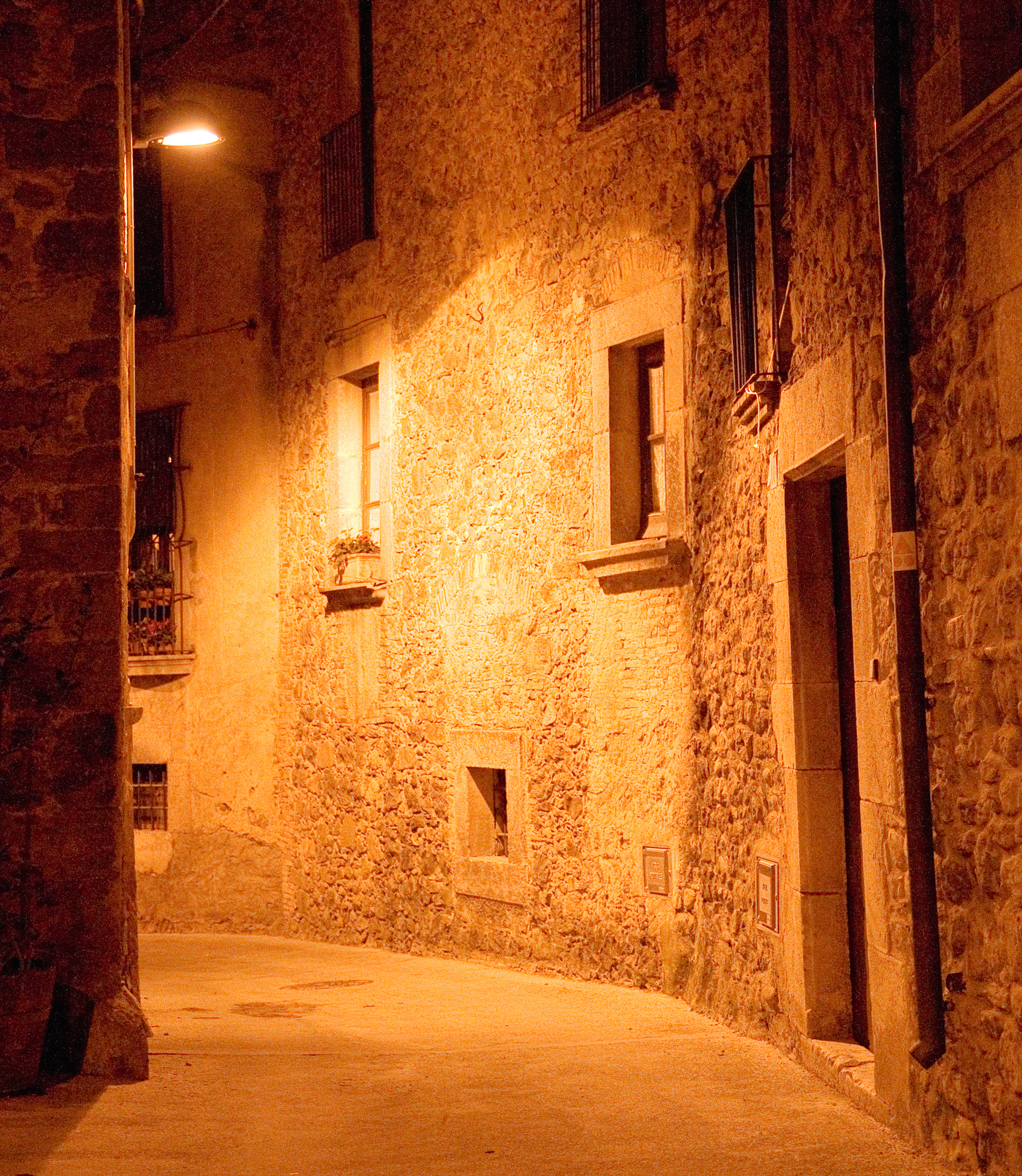 Medieval narrow dark alley at night photo