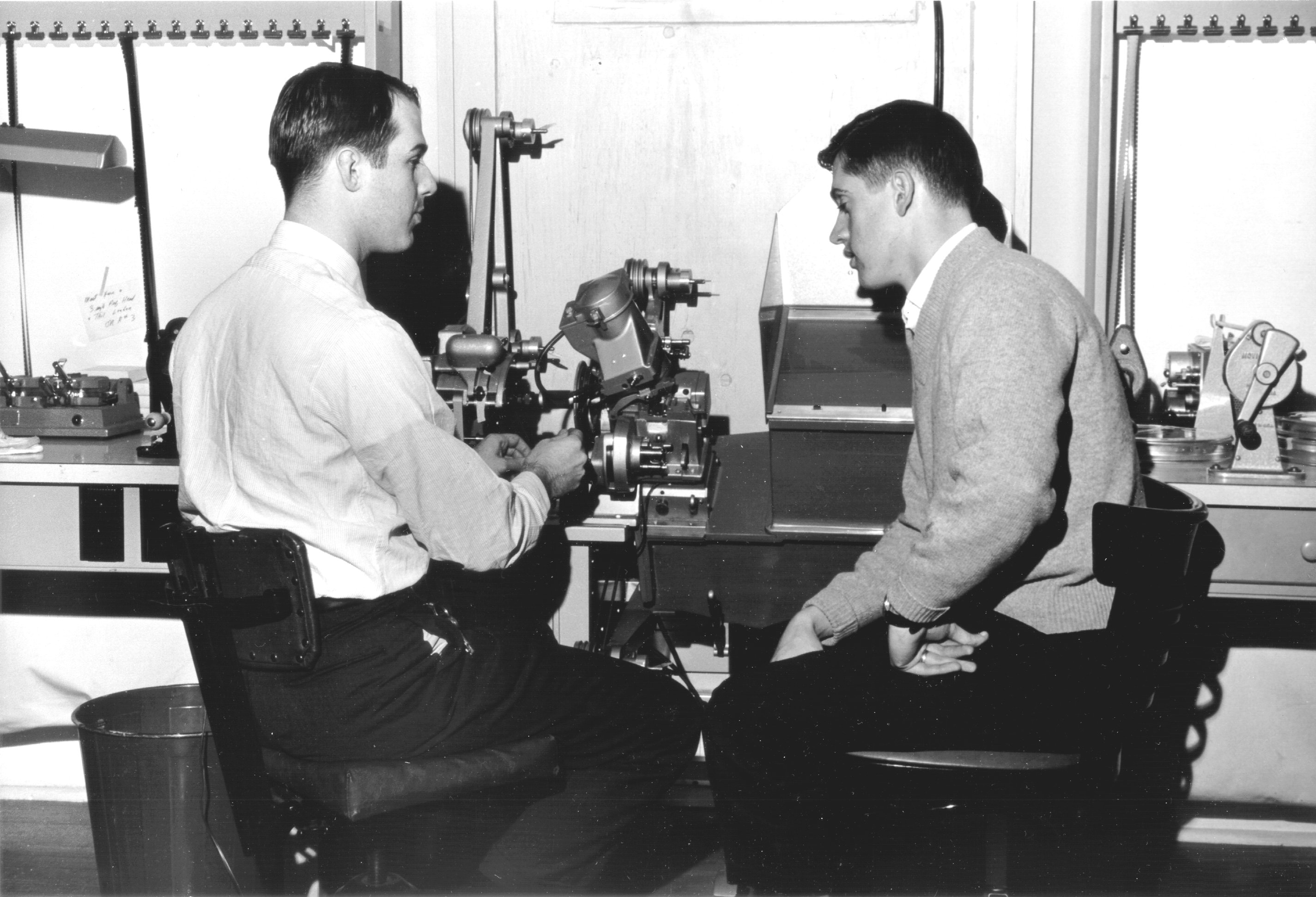 Two men working with film editing equipment - Kentucky Digital Library