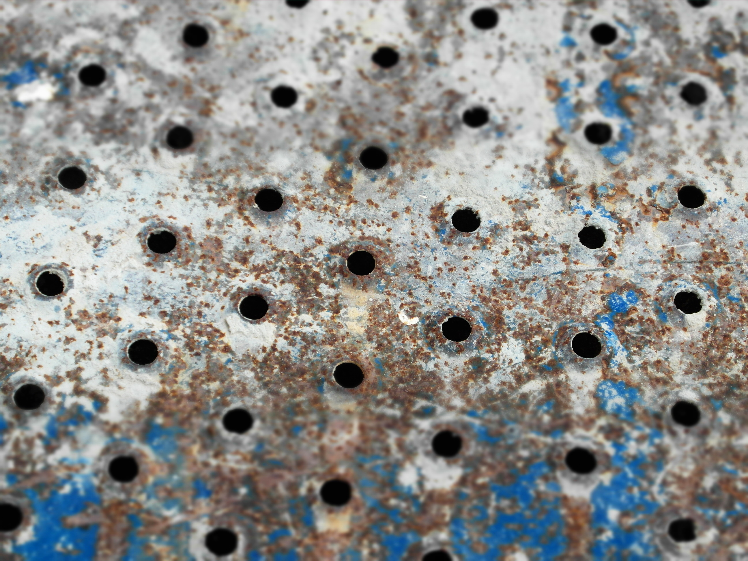 Metal holes rusted background photo