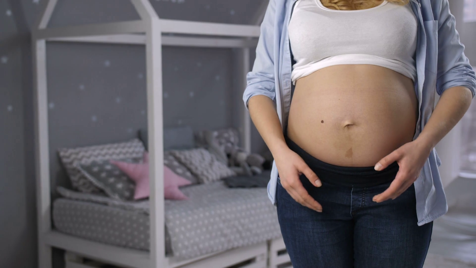 Midsection of expecting woman standing with naked pregnant belly and ...