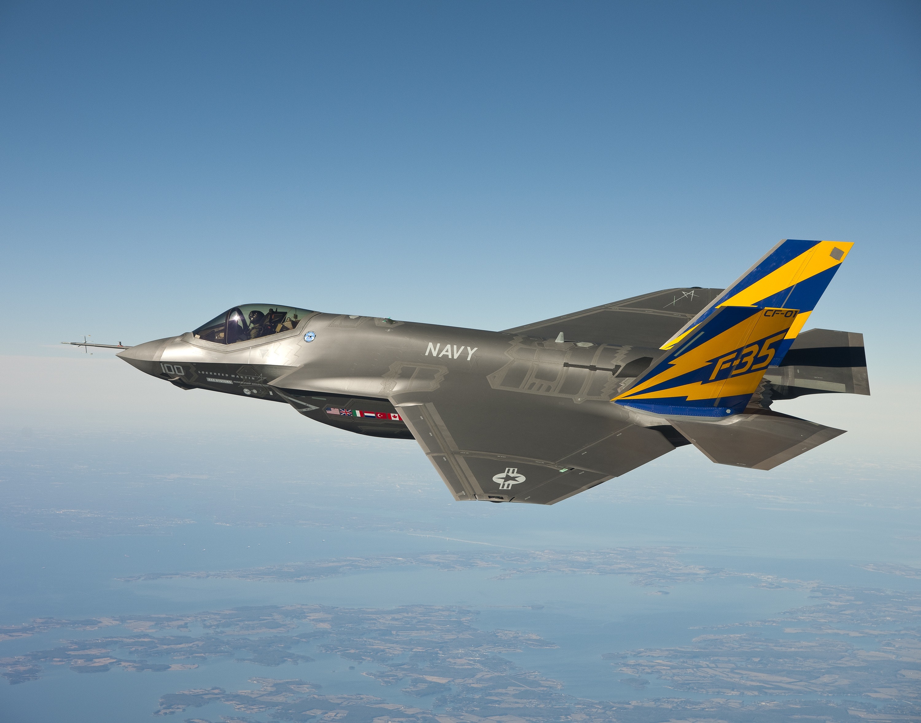 Grey Blue and Yellow Navy F 35 Fighter Plane Flying on Clear Blue ...