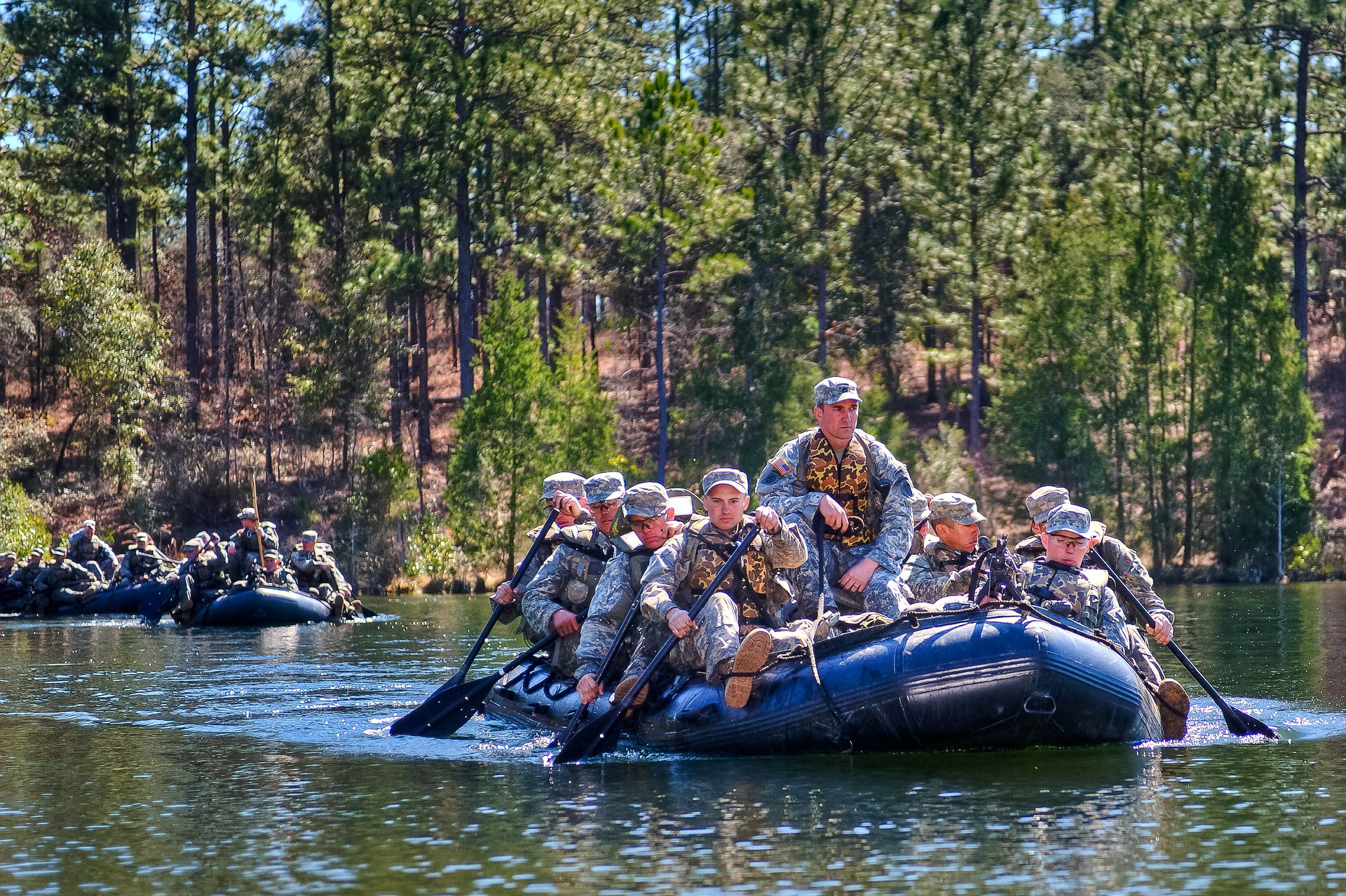 Military men crossing the river photo