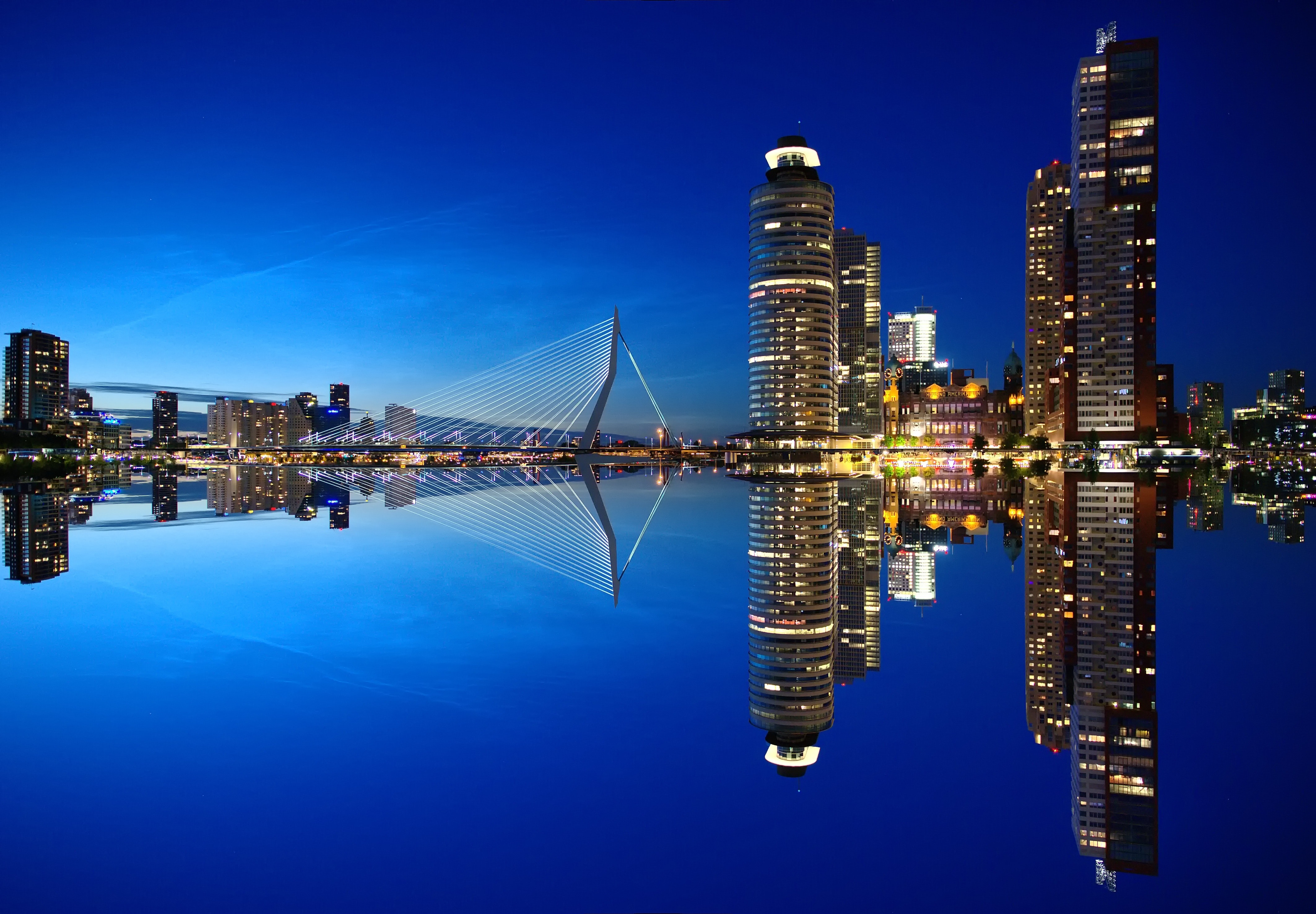 Mirrored image of high rise buildings and bridge photo