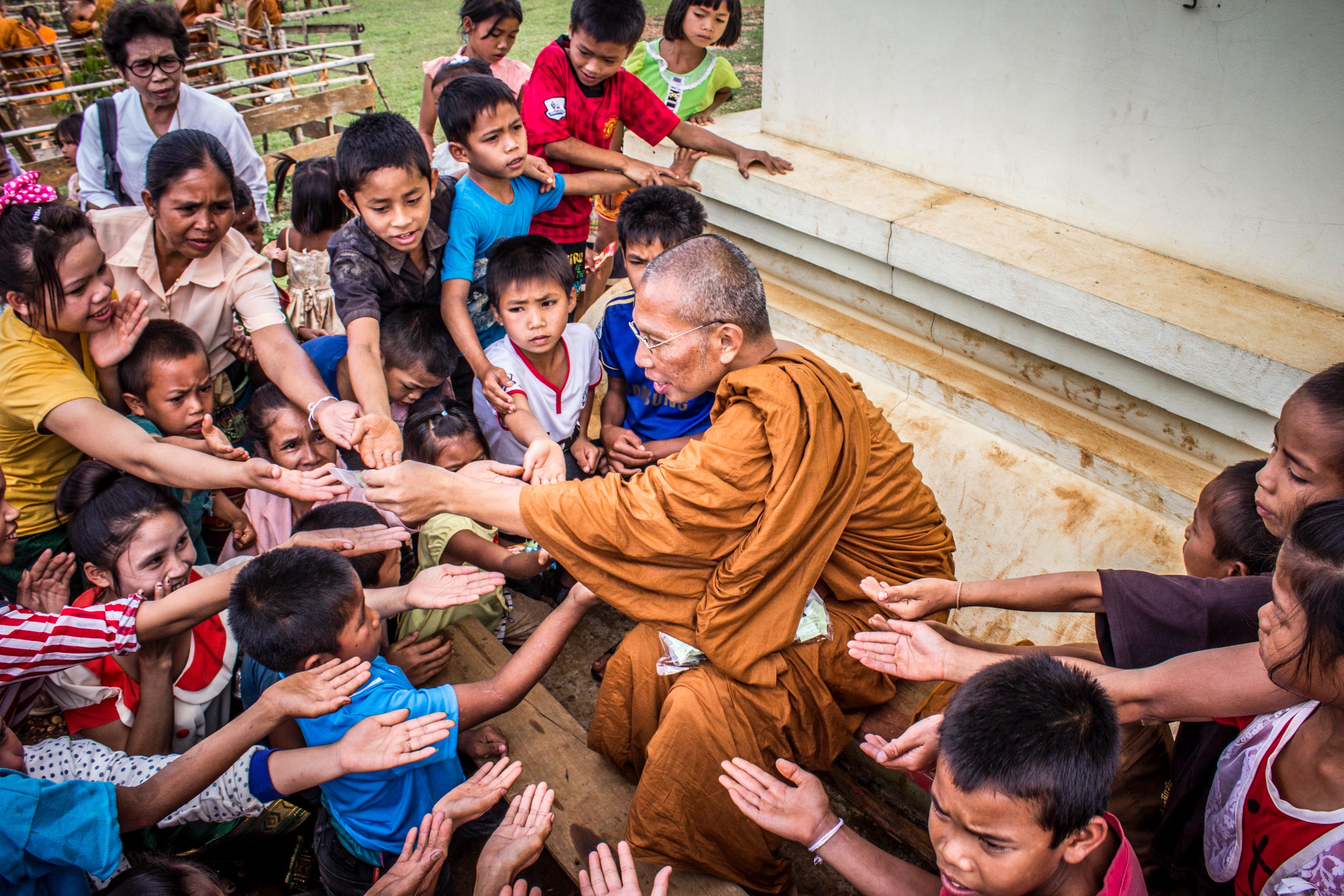 Monk surrounded by children photo