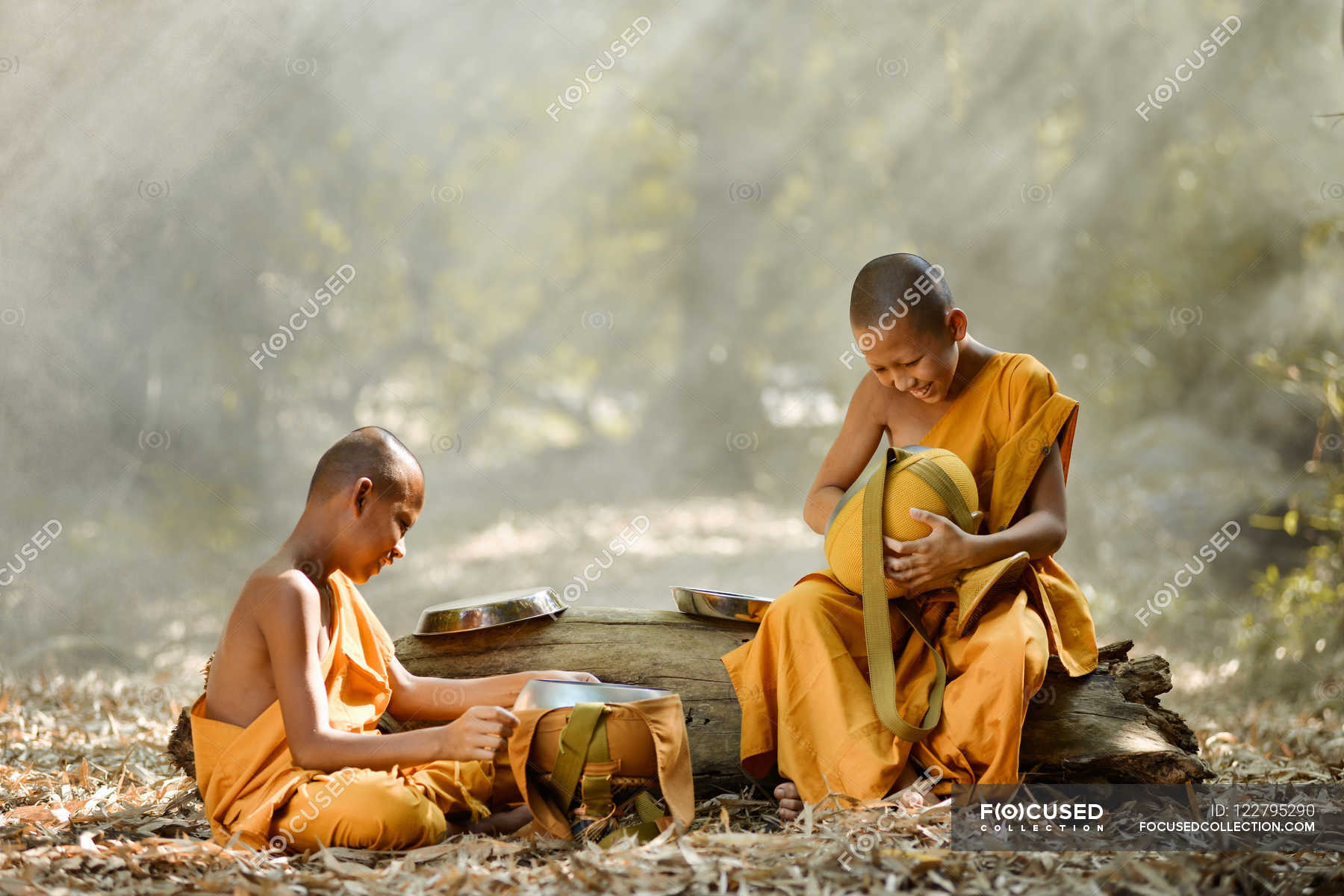 Buddhist monks sitting in forest — Stock Photo | #122795290