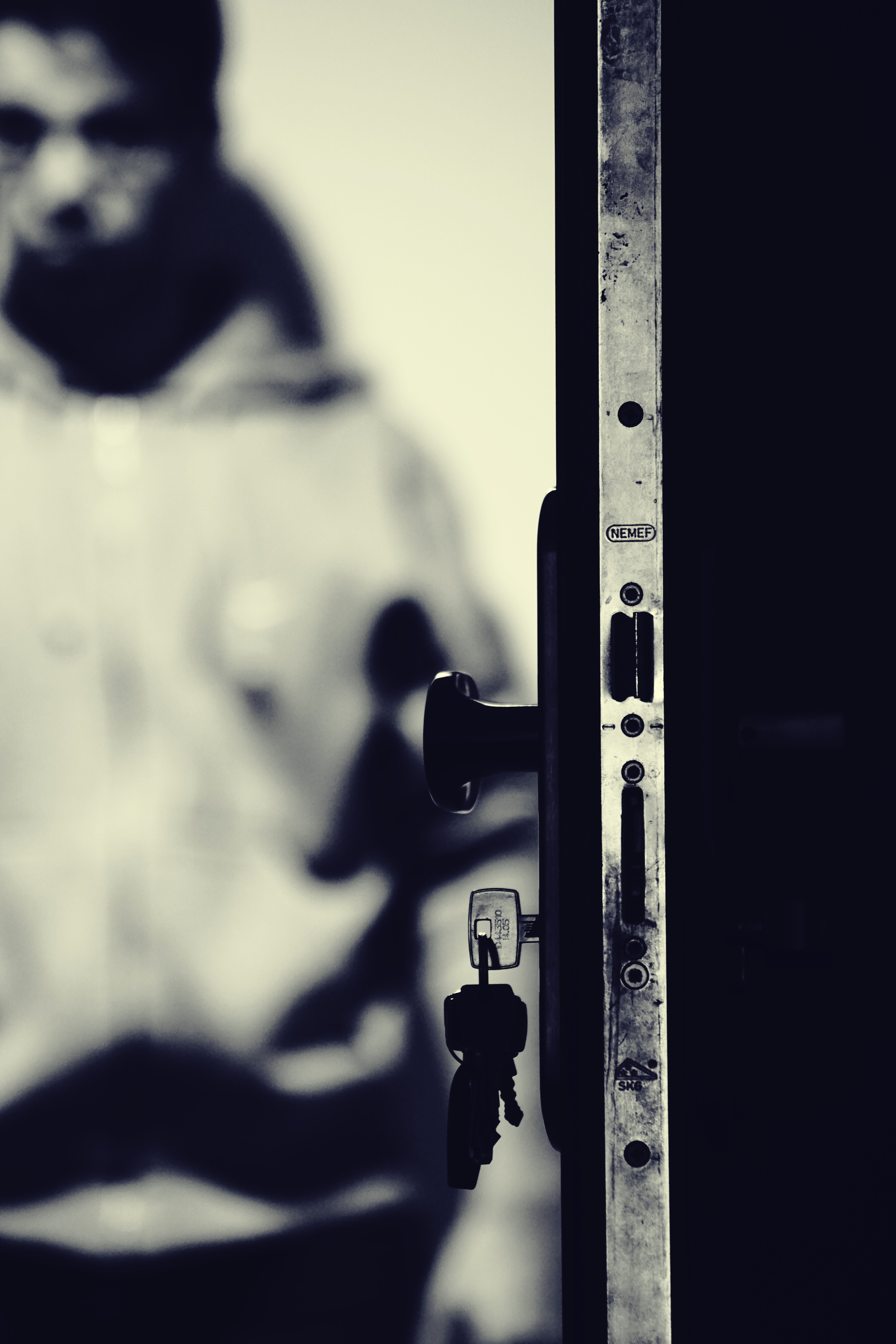 Monochrome photo of keys and door knob