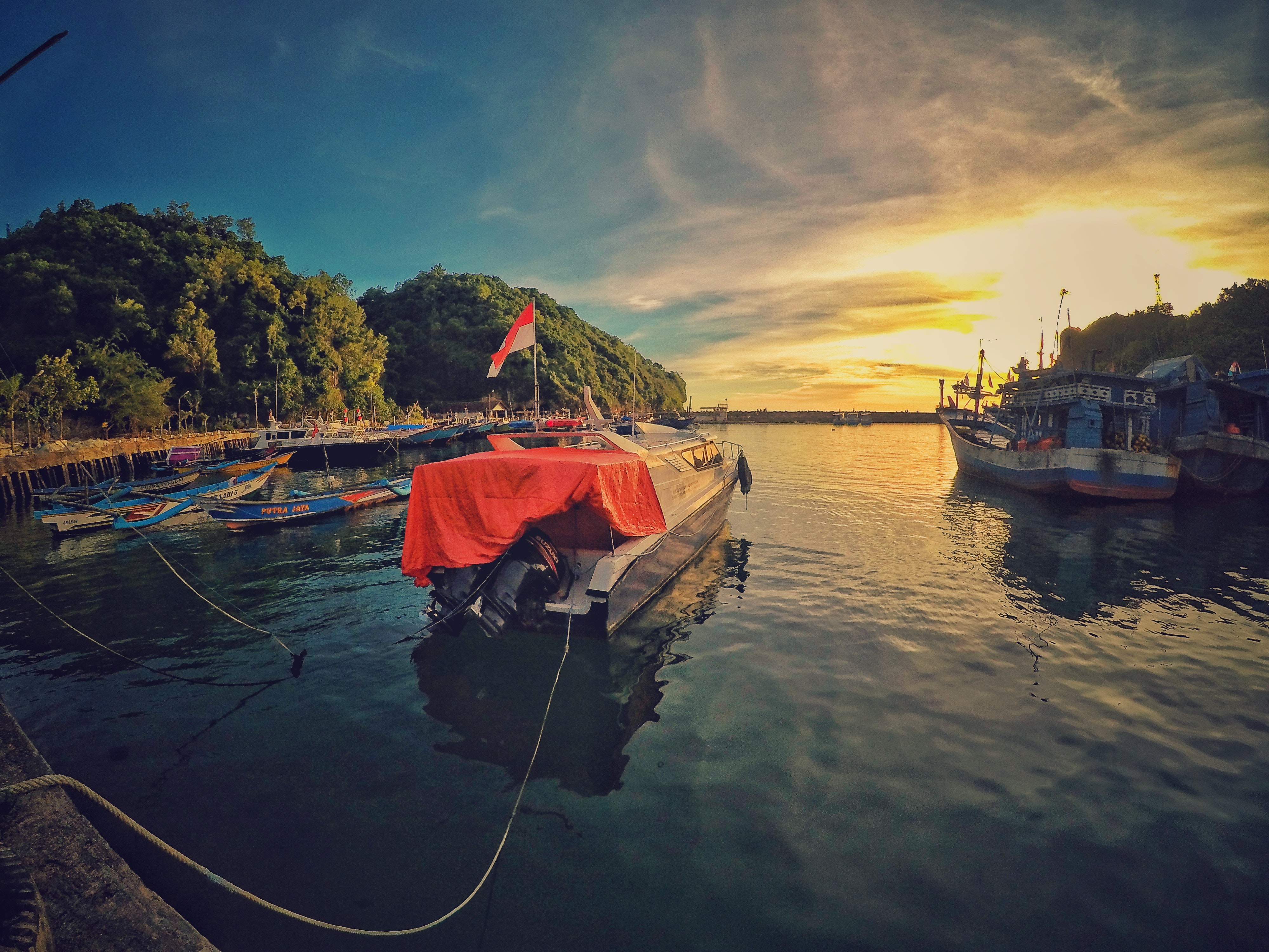 Motor boat near dock during sunset photo