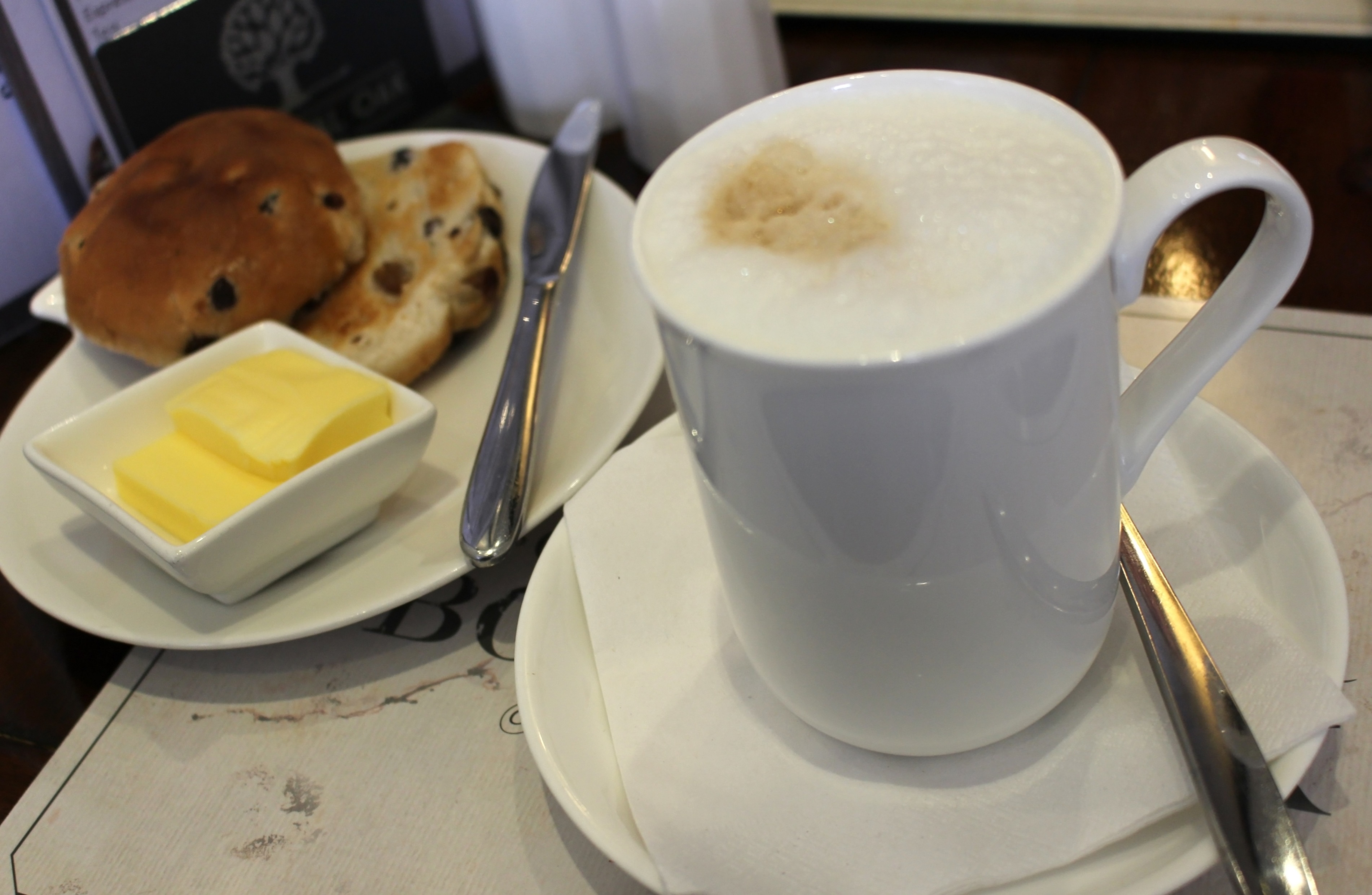 Mug of coffee with toasted teacake photo