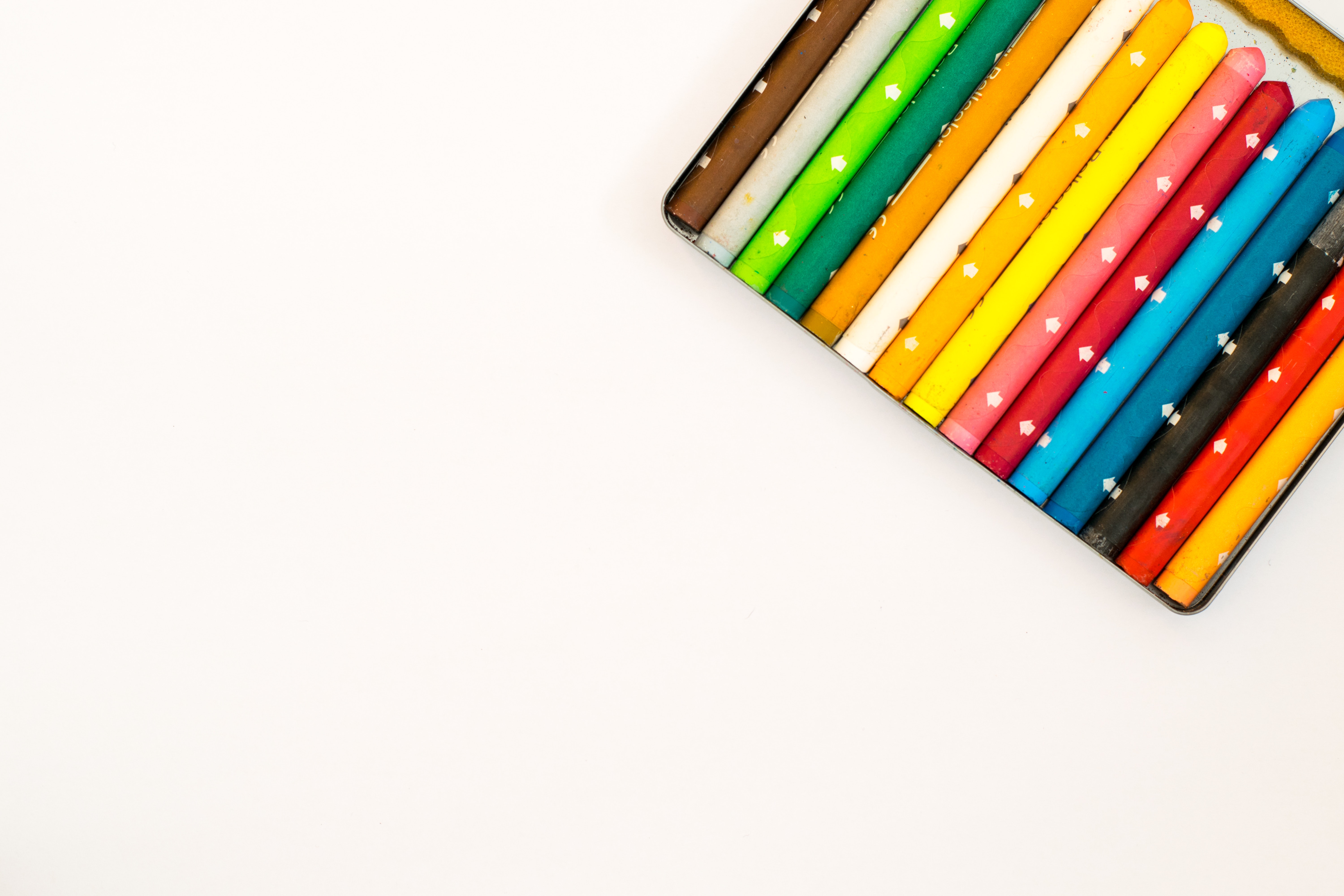 Multi colored pencils over white background photo