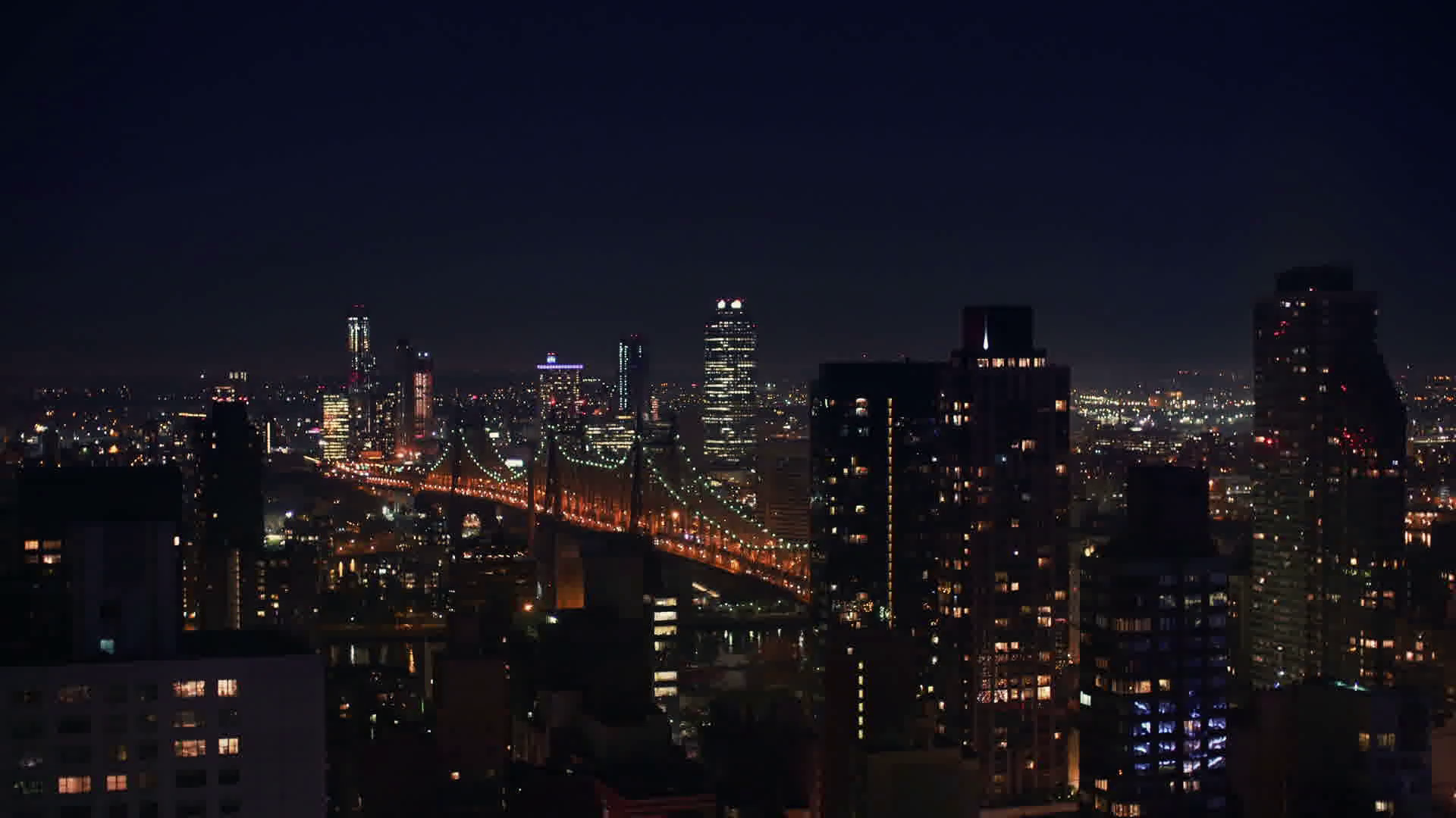 NYC at night from an apartment balcony overlooking Queensboro Bridge ...