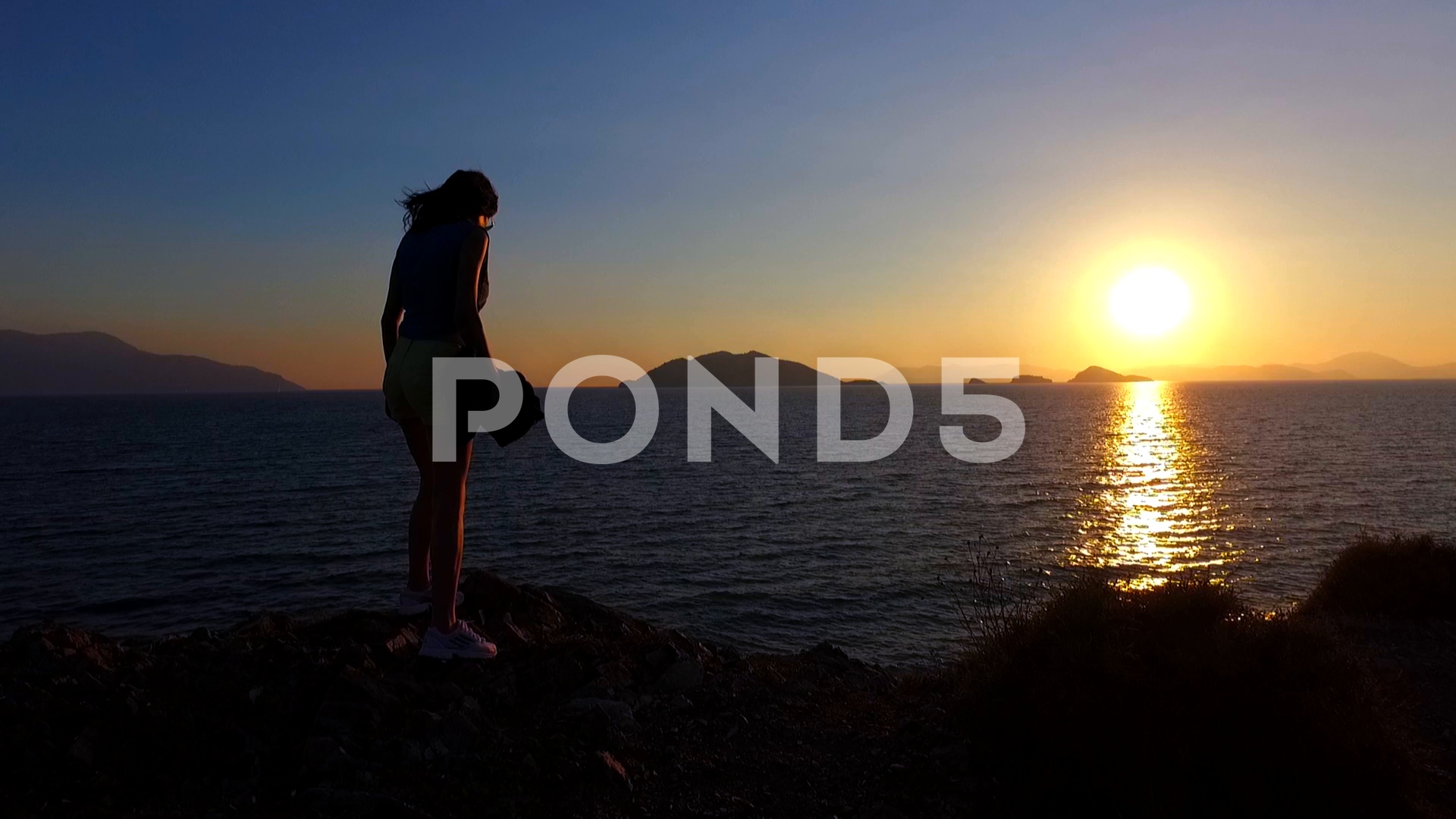 Woman Observing the Sunset ~ Hi Res Video #70950711