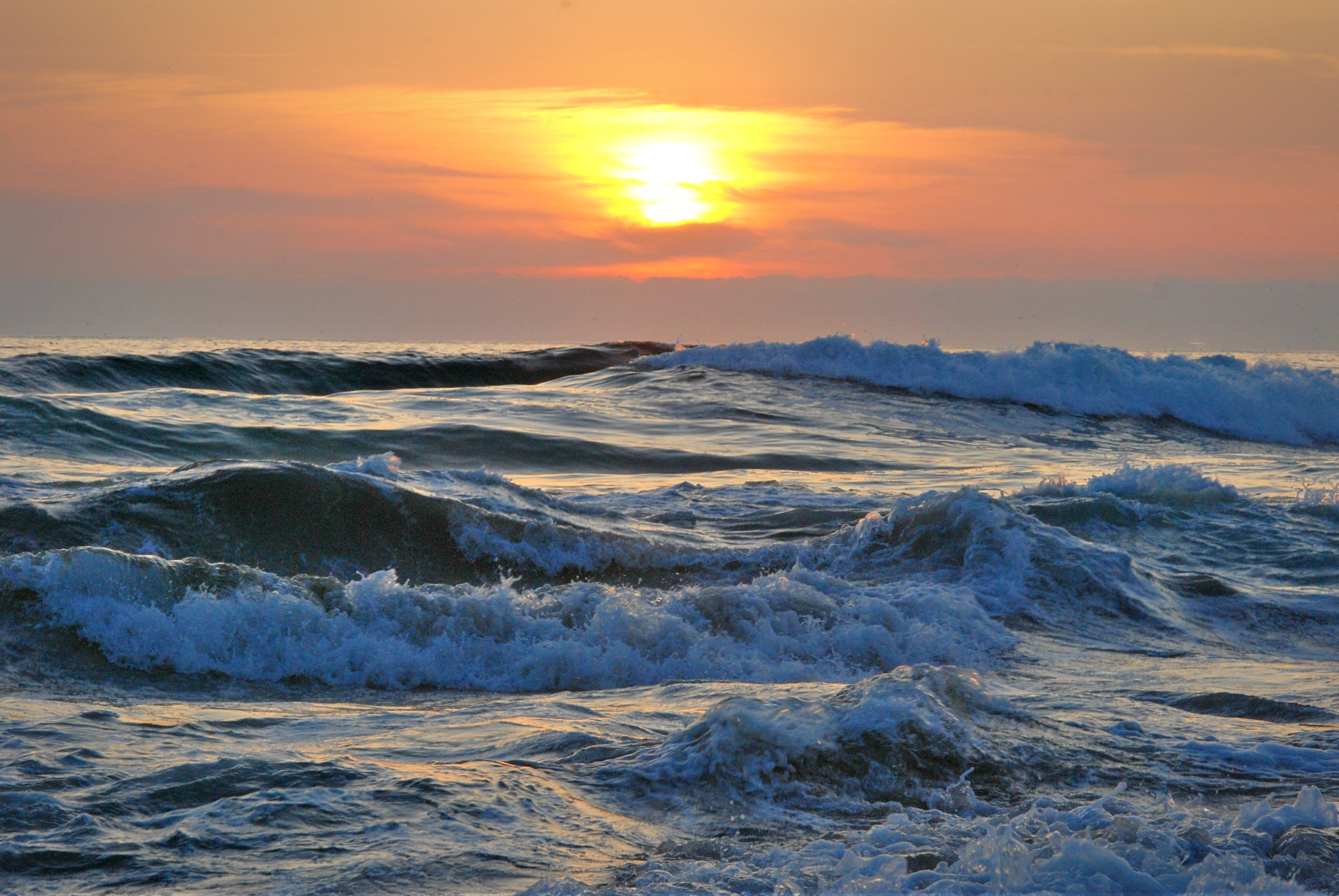 Ocean water during yellow sunset photo