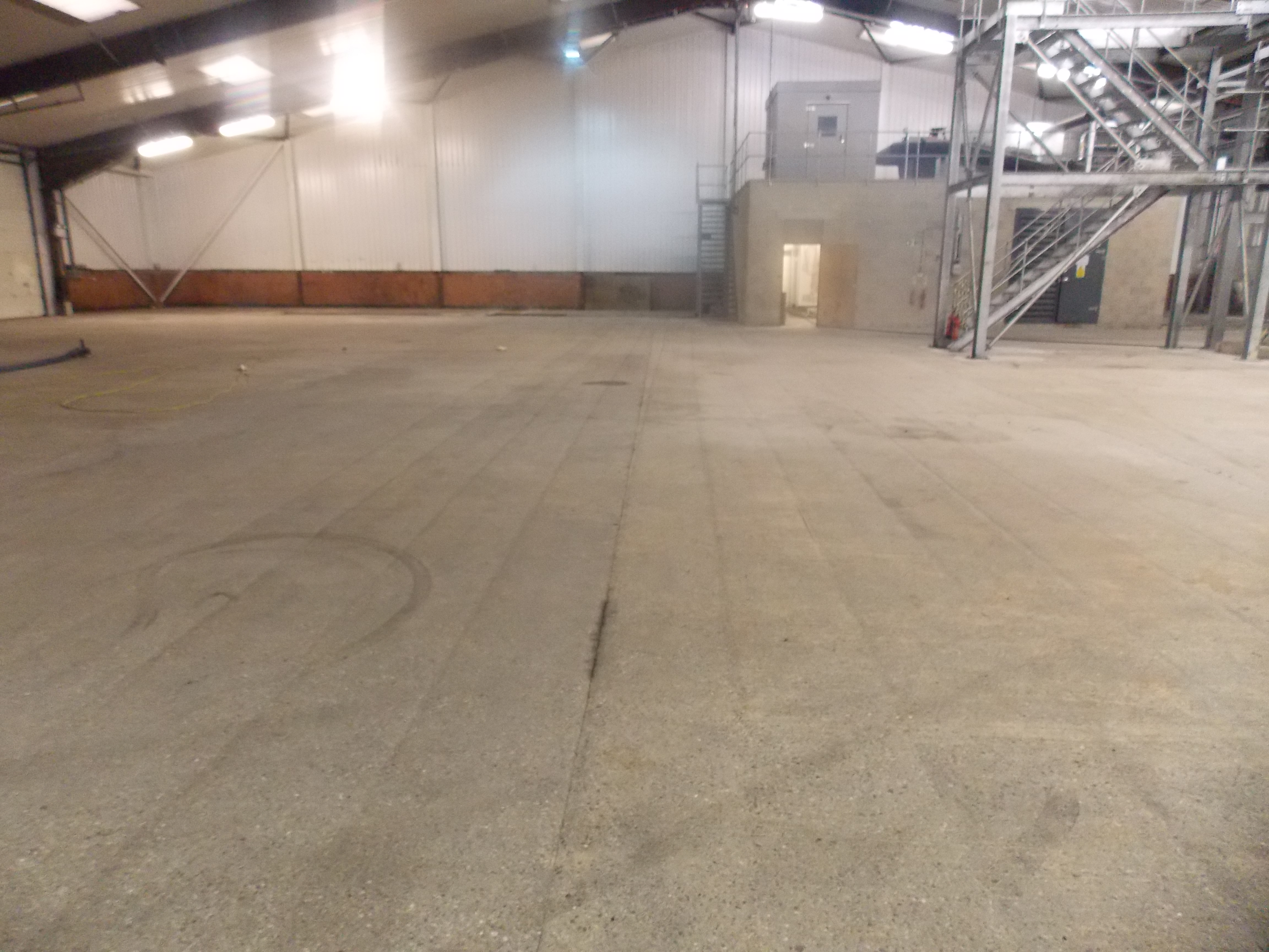 Black oily and dirty concrete floor slab restored by captive shot ...