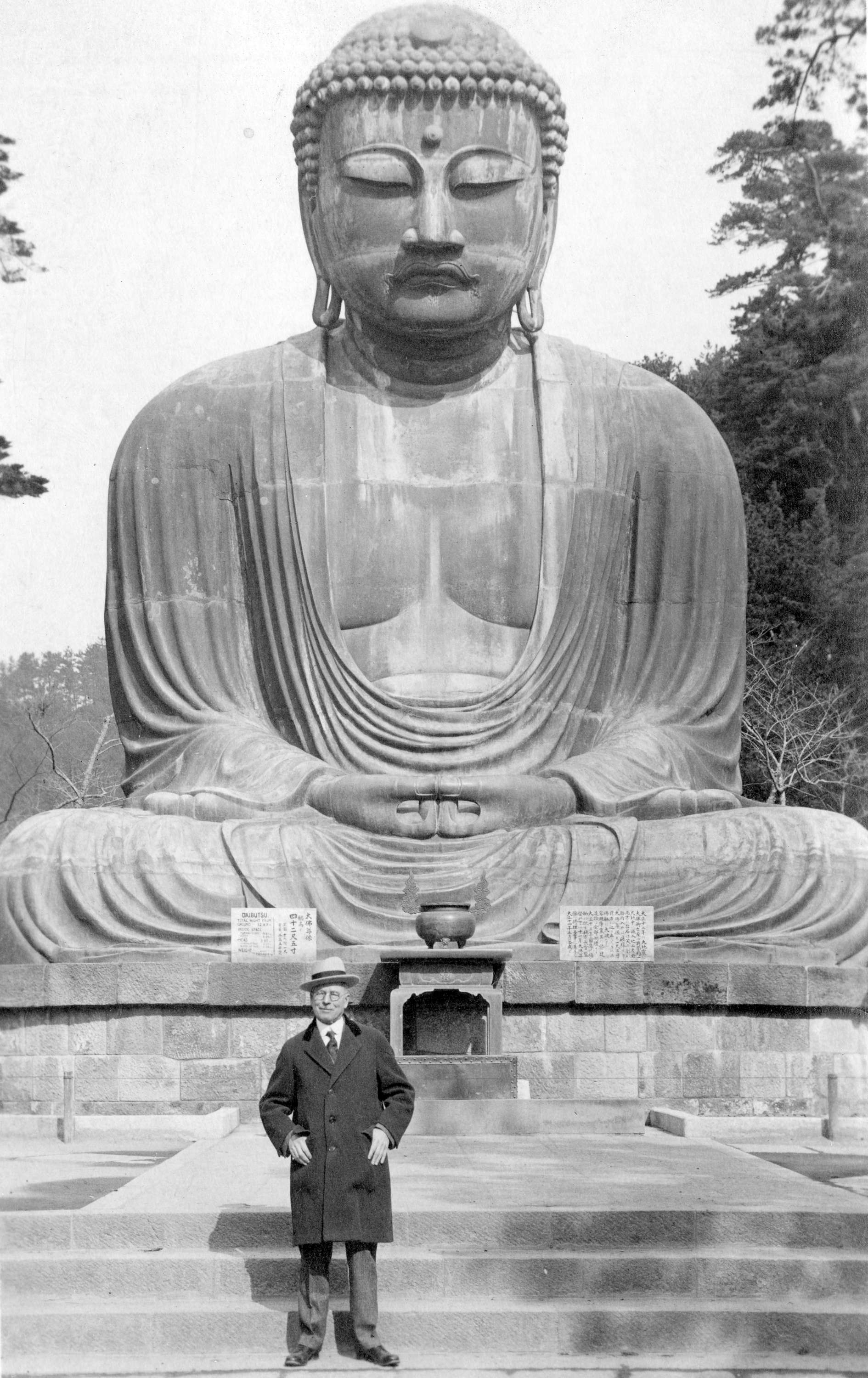 L.D. Taylor standing in front of a buddha statue in] Kamakura Japan ...